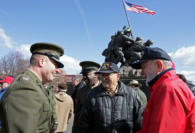 Col. William K. Lietzau, the commanding officer of Headquarters Battalion, Headquarters Marine Corps, stands with two Marine veterans who fought in the battle of Iwo Jima during World War II, just moments after a flag raising ceremony Feb. 23 at the Marine Corps War Memorial in Arlington, Va.  Active duty and reserve Marines, Marine veterans, retired Marines and civilian spectators gathered at the memorial, which depicts the five Marines and one Navy corpsman raising the American flag on Mount Suribachi during World War II, to observe the 64th anniversary of the actual flag-raising.