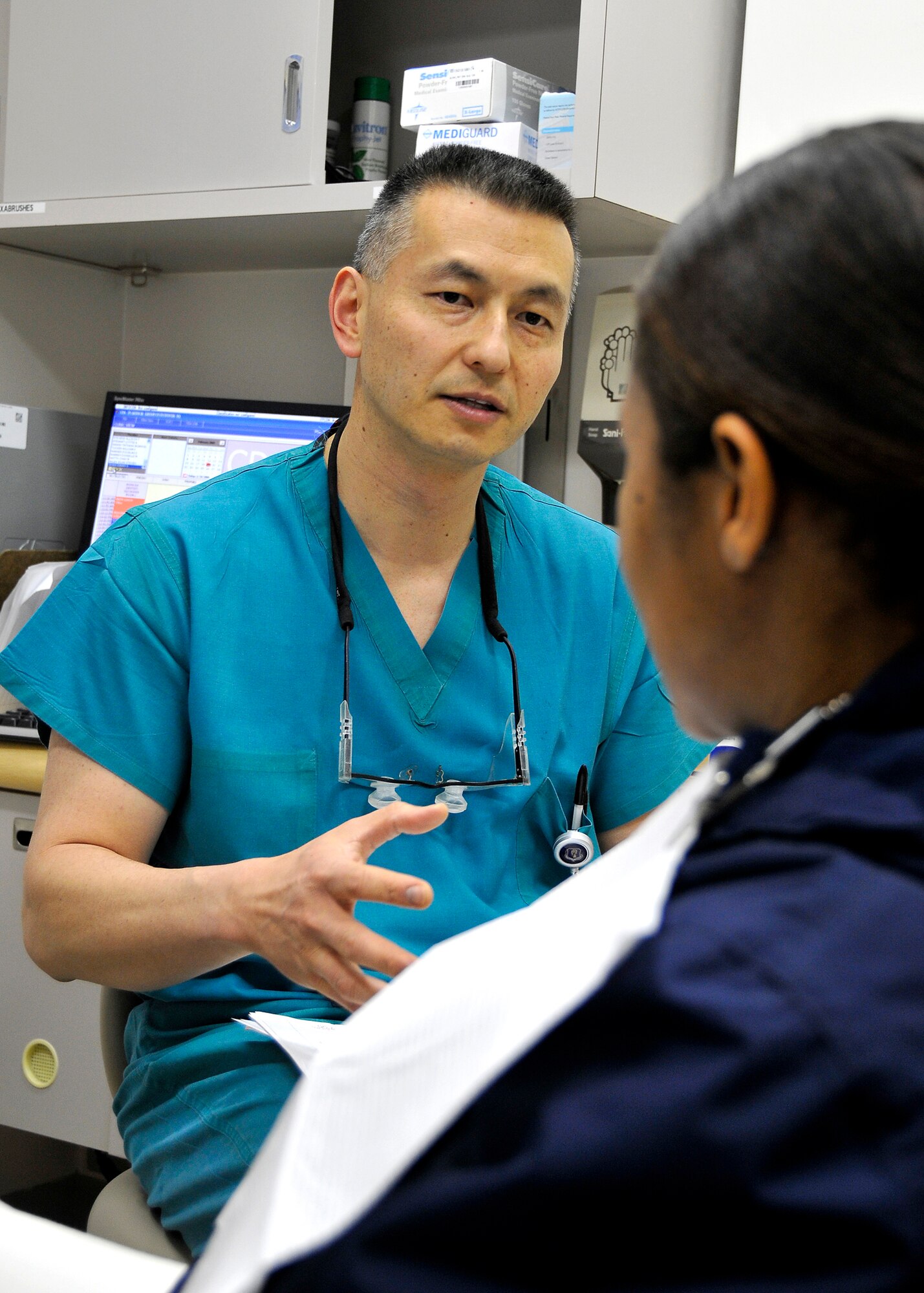 MISAWA AIR BASE, Japan -- Lt. Col. Danny Wong, 35th Dental Squadron clinical dentistry flight commander, talks with a patient Feb. 19, 2009. Colonel Wong is from Antioch, California and is the 2008 Air Force Outstanding Dental Officer of the year. (U.S. Air Force photo by Senior Airman Chad Strohmeyer)