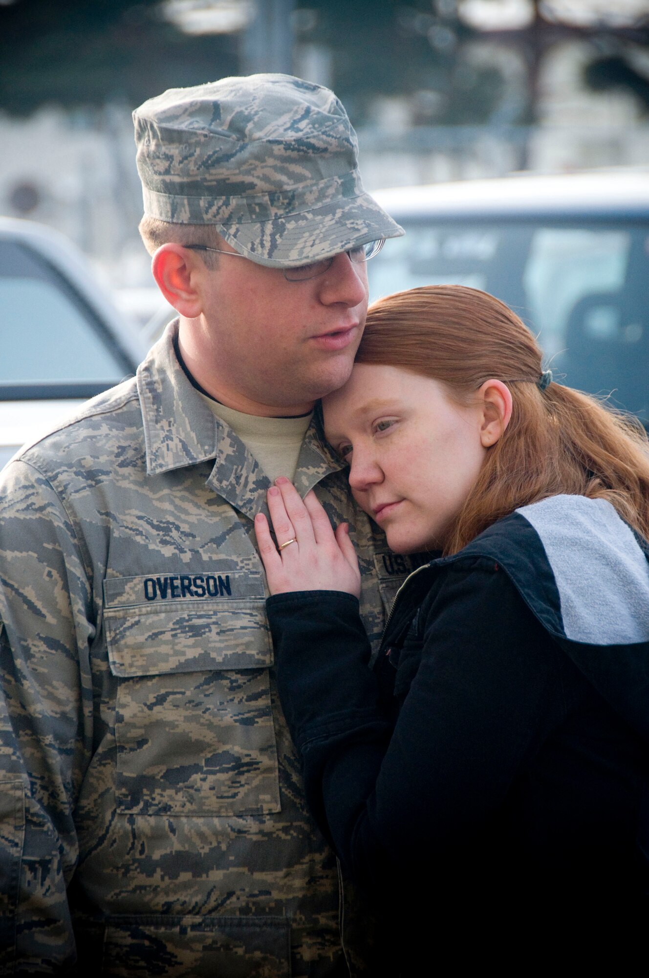 MISAWA AIR BASE, Japan -- Airman 1st Class Tristan Overson, 13th Aircraft Maintenance Unit crewchief, holds his wife Kara while waiting to leave Feb. 24, 2009. Airman Overson is deploying with his unit to South Korea in support of the 13th Fighter Squadron. He is from El Paso, Texas. (U.S. Air Force photo by Staff Sgt. Samuel Morse)