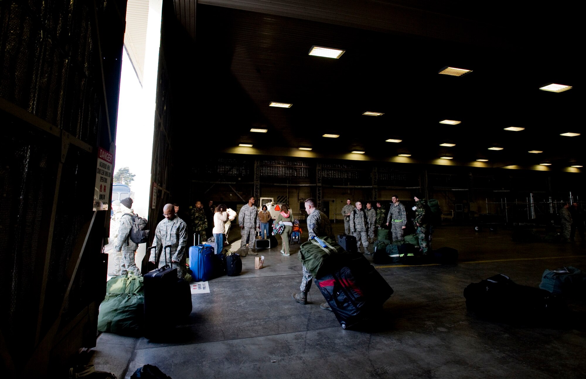 MISAWA AIR BASE, Japan -- Members of the 13th Aircraft Maintenance Unit prepare baggage for their deployment to South Korea Feb. 24, 2009. The families of the deploying Airmen said their goodbyes as the Airmen boarded the bus to the passenger terminal. (U.S. Air Force photo by Staff Sgt. Samuel Morse)