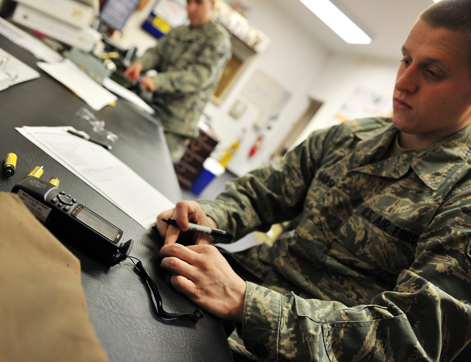 Airman 1st Class Josh Harsh, Aircrew Life Support Apprentice, 18th Aggressor Squadron, marks the date batteries are put into a global positioning system Feb. 23, 2009, Eielson Air Force Base, Alaska. Aircrew Life Support periodically inspects flight equipment for safety precautions.  (U.S. Air Force photo/Airman 1st Class Willard E. Grande II)
