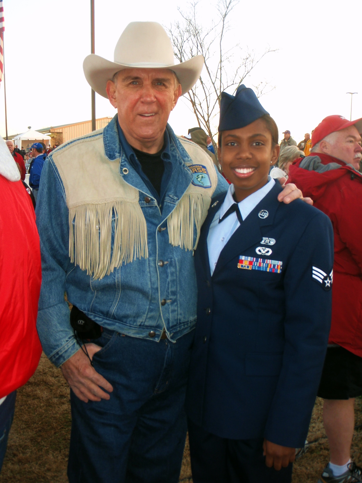 Senior Airman Chonte Walker, 2d Civil Engineer Squadron, posed for a quick picture after singing the National Anthem with Ray Scott, founder of the Bass Anglers Sportsman Society and creator of the first national bass tournament trail. Airman Walker sang the National Anthem all three days of the classic for an estimated crowd near 20,000. (U.S. Air Force photo by 2d. Lt Amy Abbott)