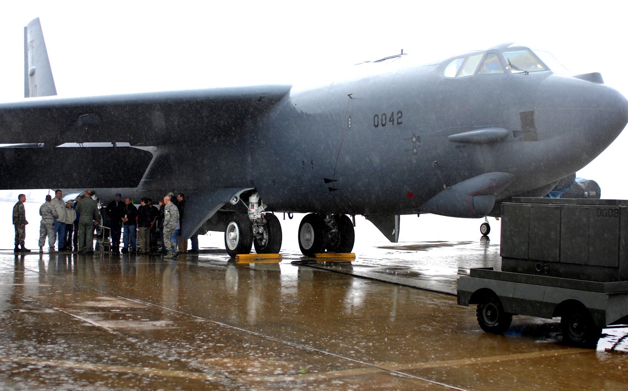 Members of ESPN and their distinguished visitors braved the puring rain for a tour of a B-52 provided by the 917th Wing Feb. 21. Capt. Jerry Reynolds, 93rd Bomb Squadron, B-52 instructor aircraft commander, along with flight chiefs discussed the capabilities of the aircraft and answered questions. (U.S. Air Force photo by 2d. Lt Amy Abbott)