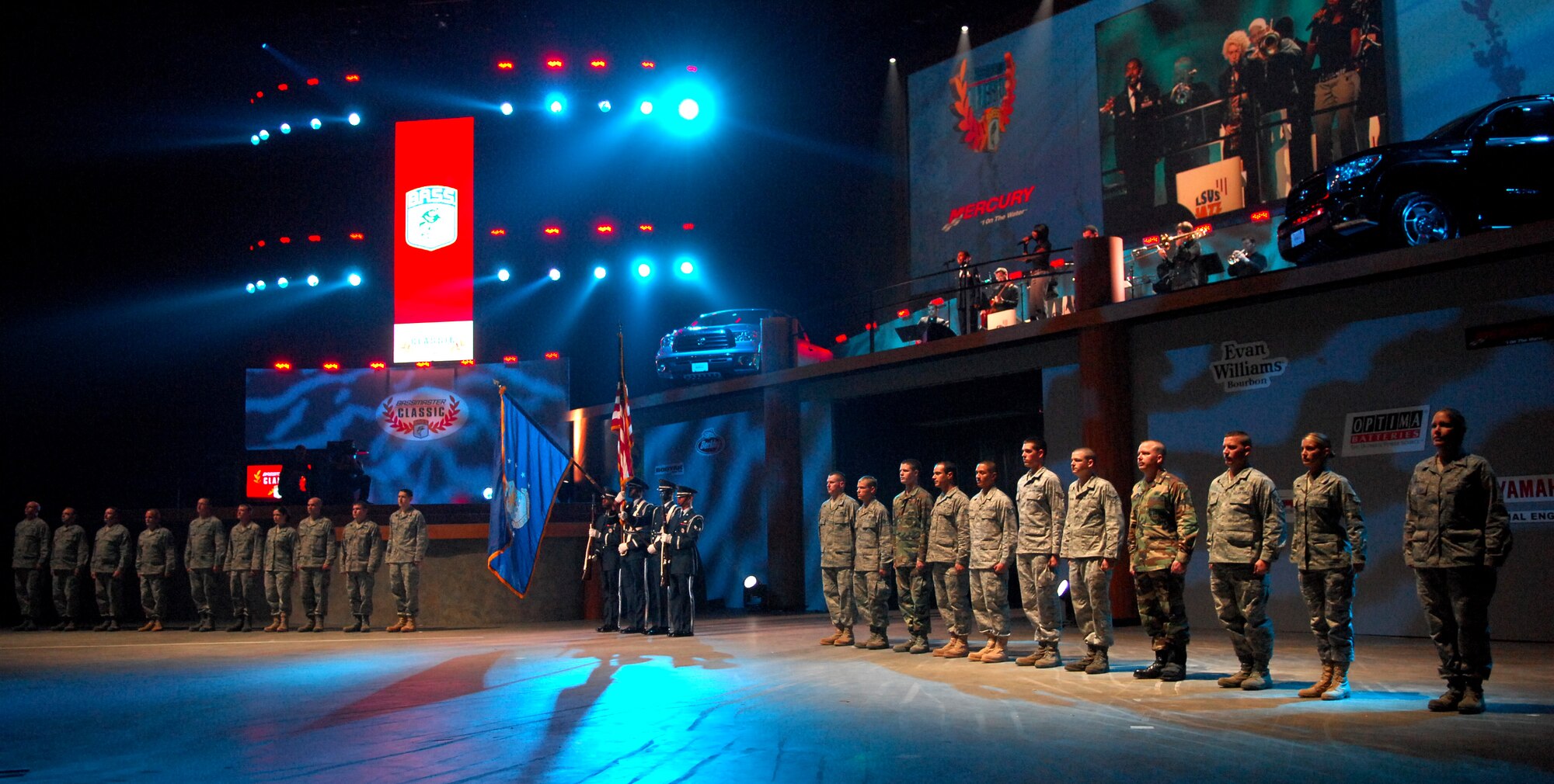 Airmen from Barksdale Air Force Base, La., stand on stage with the Barksdale Honor Guard during the opening ceremonies of the day one weigh in for the 2009 ESPN Bassmaster Classic. Senior Airman Chonte Walker, 2d Civil Engineer Squadron, stands overhead singing the National Anthem. (U.S. Air Force photo by 2d. Lt Amy Abbott)