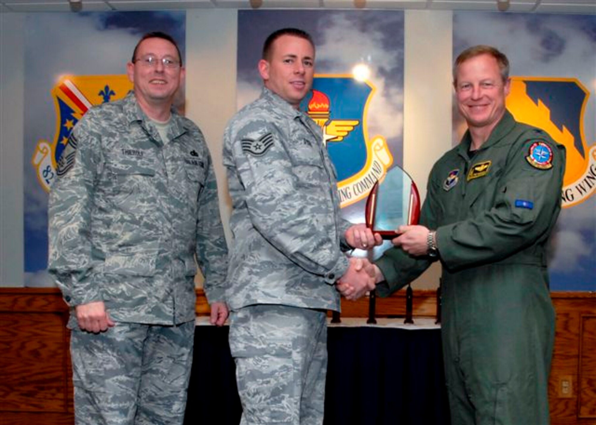 Staff Sgt. Clinton Dykes, 80th Operations Support Squadron, accepts the NCO of the Quarter Award, for the first quarter from Col. David Petersen, commander of the 80th Flying Training Wing at the wing's quarterly award luncheon. Also pictured is 80th FTW Superintendant Chief Master Sgt. Norman Thierolf. (U.S. Air Force photo)