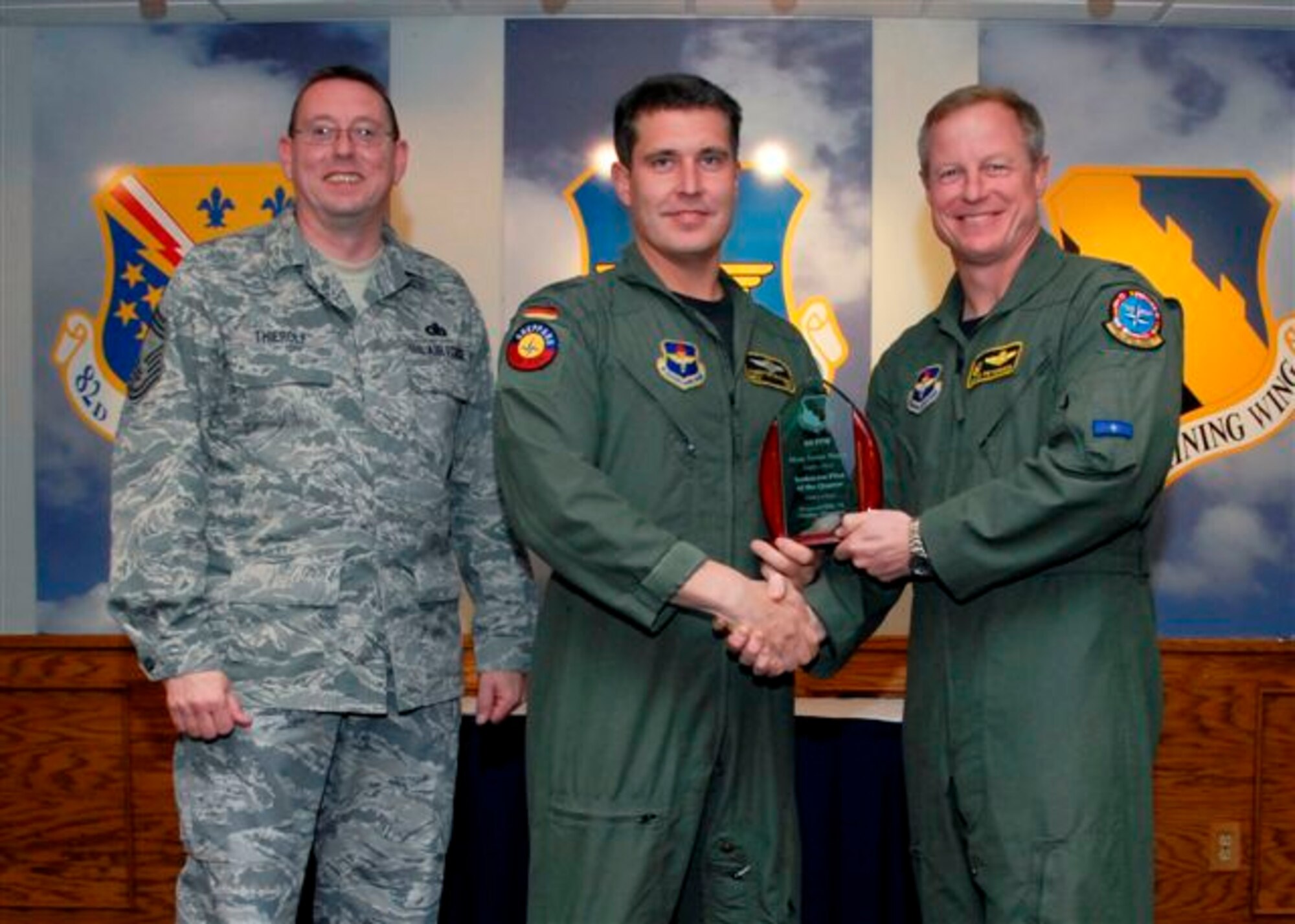 Maj. Torsten Wagner, 80th Operations Squadron, accepts the Instructor Pilot of the Quarter Award, for the first quarter from Col. David Petersen, commander of the 80th Flying Training Wing at the wing's quarterly award luncheon. Also pictured is 80th FTW Superintendant Chief Master Sgt. Norman Thierolf. (U.S. Air Force photo)