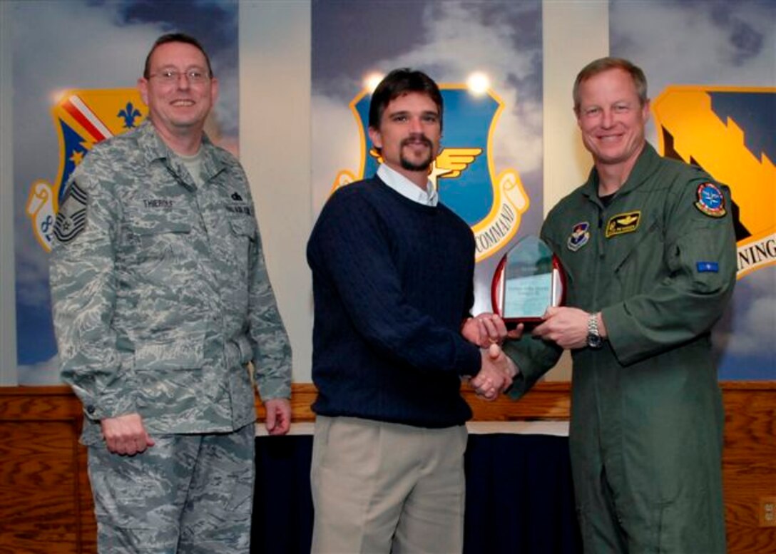 William Tisdale, 80th Operation Support Squadron, accepts the Civilian of the Quarter Award, catagory III, for the first quarter from Col. David Petersen, commander of the 80th Flying Training Wing at the wing's quarterly award luncheon. Also pictured is 80th FTW Superintendant Chief Master Sgt. Norman Thierolf. (U.S. Air Force photo)