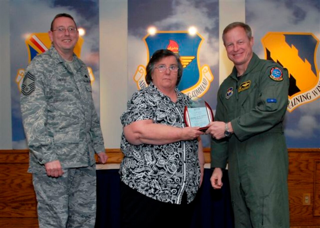 Paula Johns, 80th Flying Training Wing, accepts the Civilian of the Quarter Award, catagory I, for the first quarter from Col. David Petersen, commander of the 80th Flying Training Wing at the wing's quarterly award luncheon. Also pictured is 80th FTW Superintendant Chief Master Sgt. Norman Thierolf. (U.S. Air Force photo)