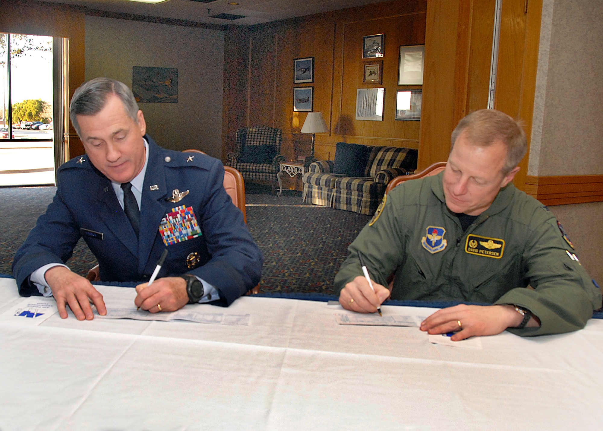 Brig. Gen. O.G. Mannon, 82nd Training Wing commander, and Col. David Petersen, 80th Flying Training Wing commander, fill out their Air Force Assistance Fund forms Feb. 20. Sheppard's fundraising cycle began Feb. 23 and will continue through April 6. (U.S. Air Force photo/Harry Tonemah) 