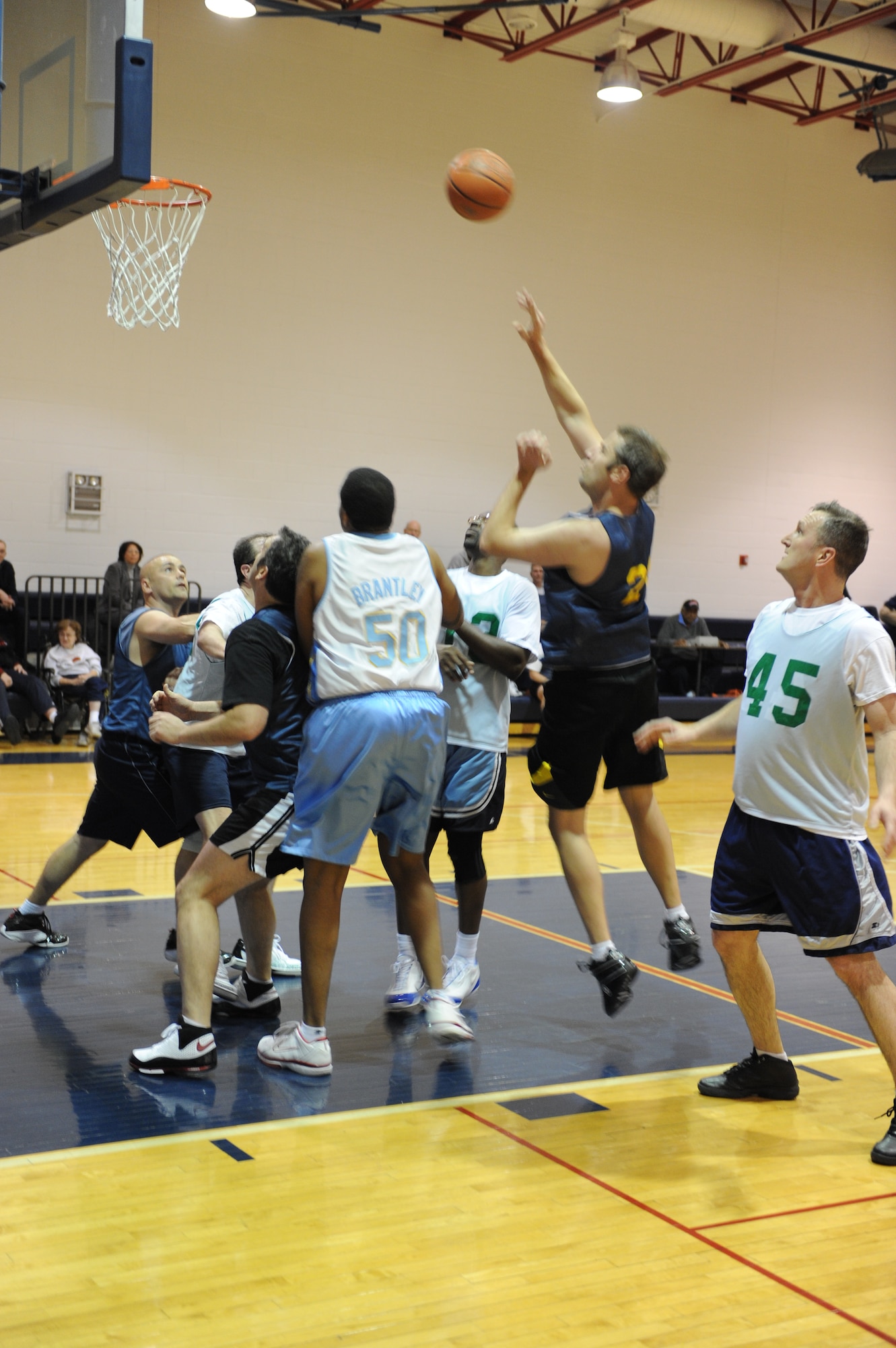 WHITEMAN AIR FORCE BASE, Mo. – John Schriever, 442nd Fighter Wing, shoots over a crowd of players during the Over-30 Basketball championship game Feb. 23 at the Whiteman Fitness Center. The 442nd FW took on the 509th Force Support Squadron winning the game in overtime with a score of 45 – 42. (U.S. Air Force photo/Senior Airman Cory Todd)