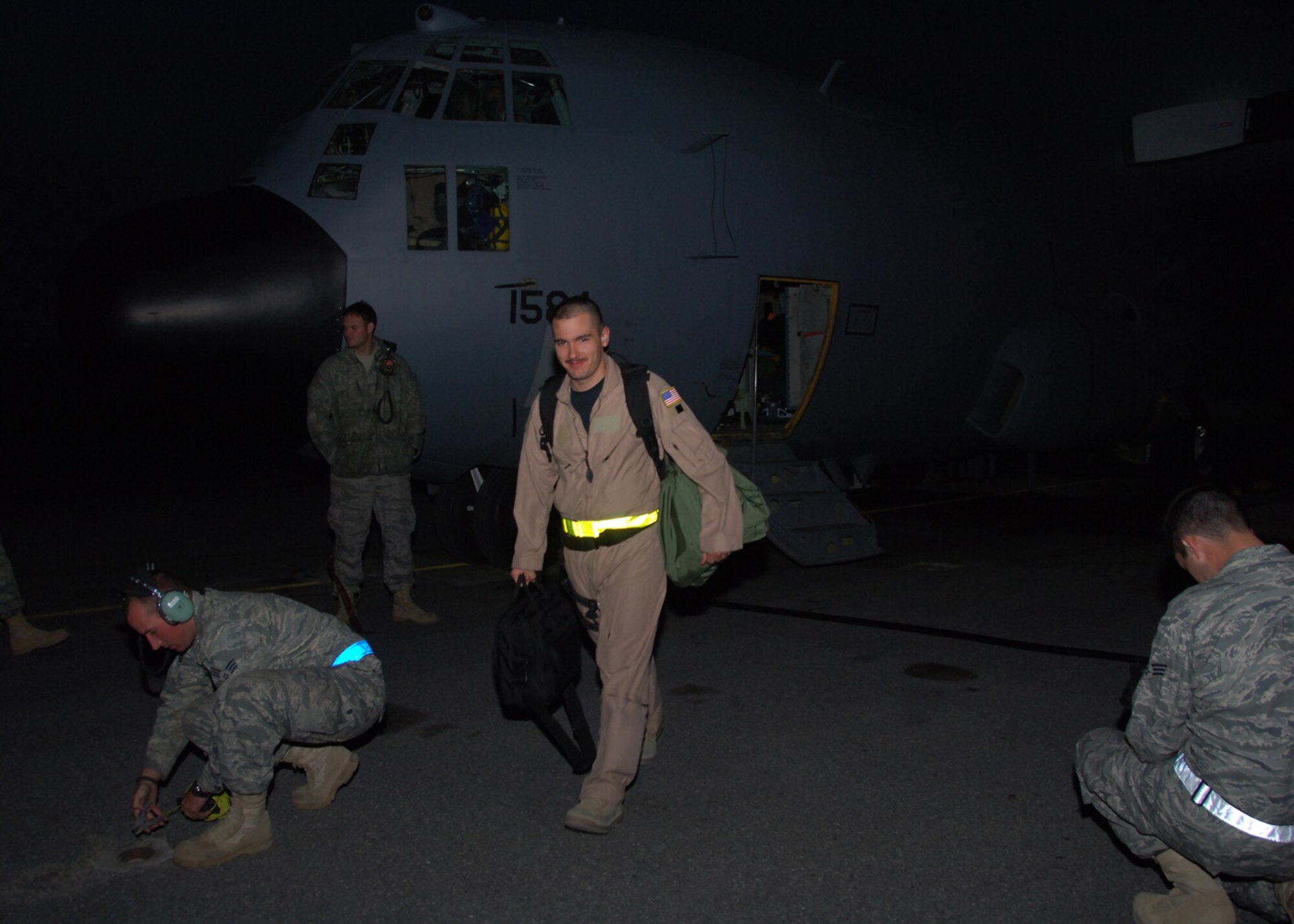 Tech. Sgt. Michael Cadette, an EC-130 Compass Call mission crew supervisor, heads to base ops at an air base in Southwest Asia, after a mission Feb. 17. Aircrews with the 43rd Expeditionary Electronic Combat Squadron flying the EC-130s have provided communications jamming support to U.S. and coalition ground forces for an accumulated 20,000 combat flight hours. (U.S. Air Force photo/Senior Airman Courtney Richardson)