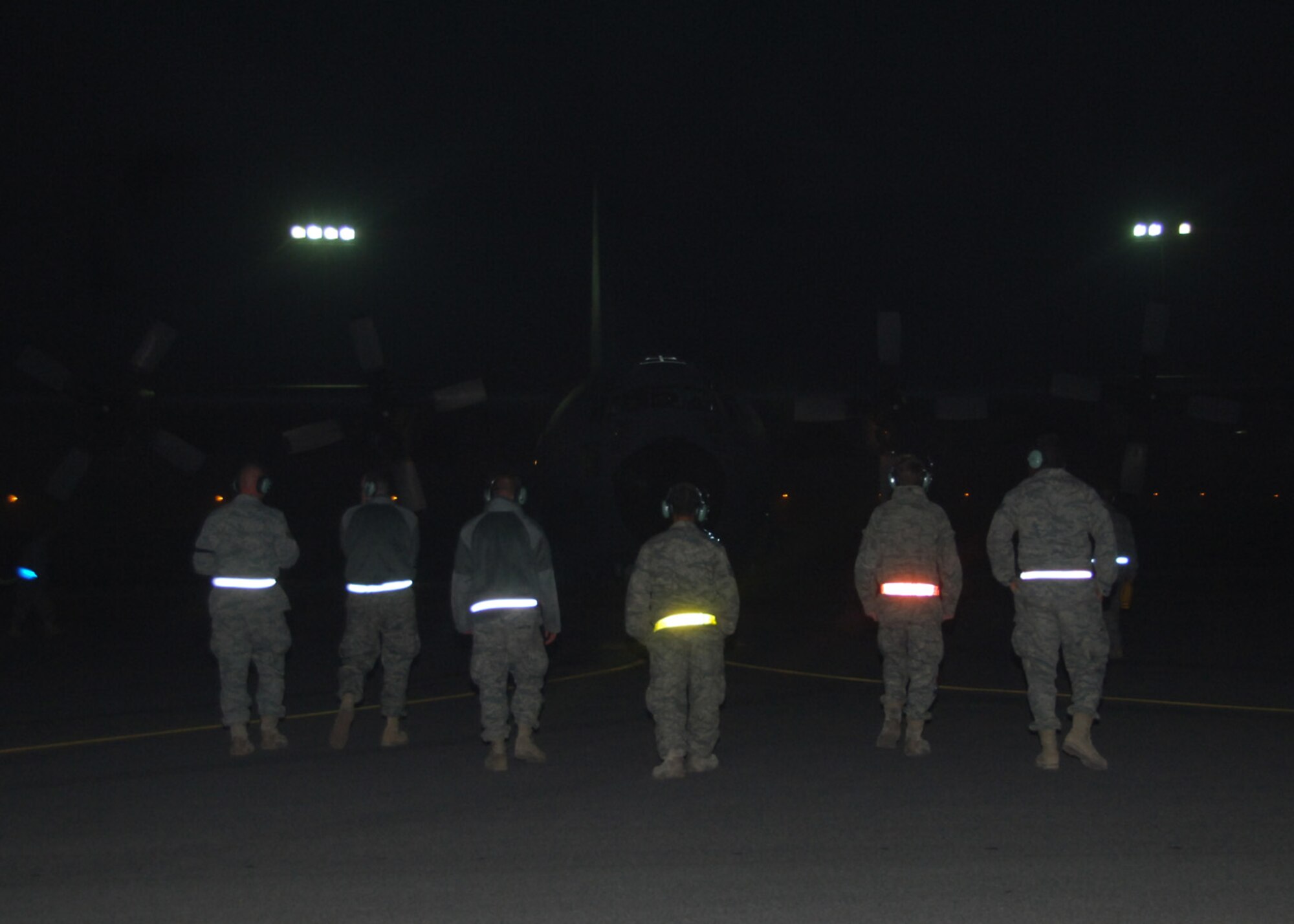 Maintainers from the 43rd Expeditionary Electronic Combat Squadron proceed to an EC-130 Compass Call aircraft at an air base in Southwest Asia to run system and maintenance checks Feb. 17 following a mission. The aircrew with the 43rd EECS had just completed the 20,000th combat flight hour for the unit, which has had five years of continuous deployment. (U.S. Air Force photo/Senior Airman Courtney Richardson)