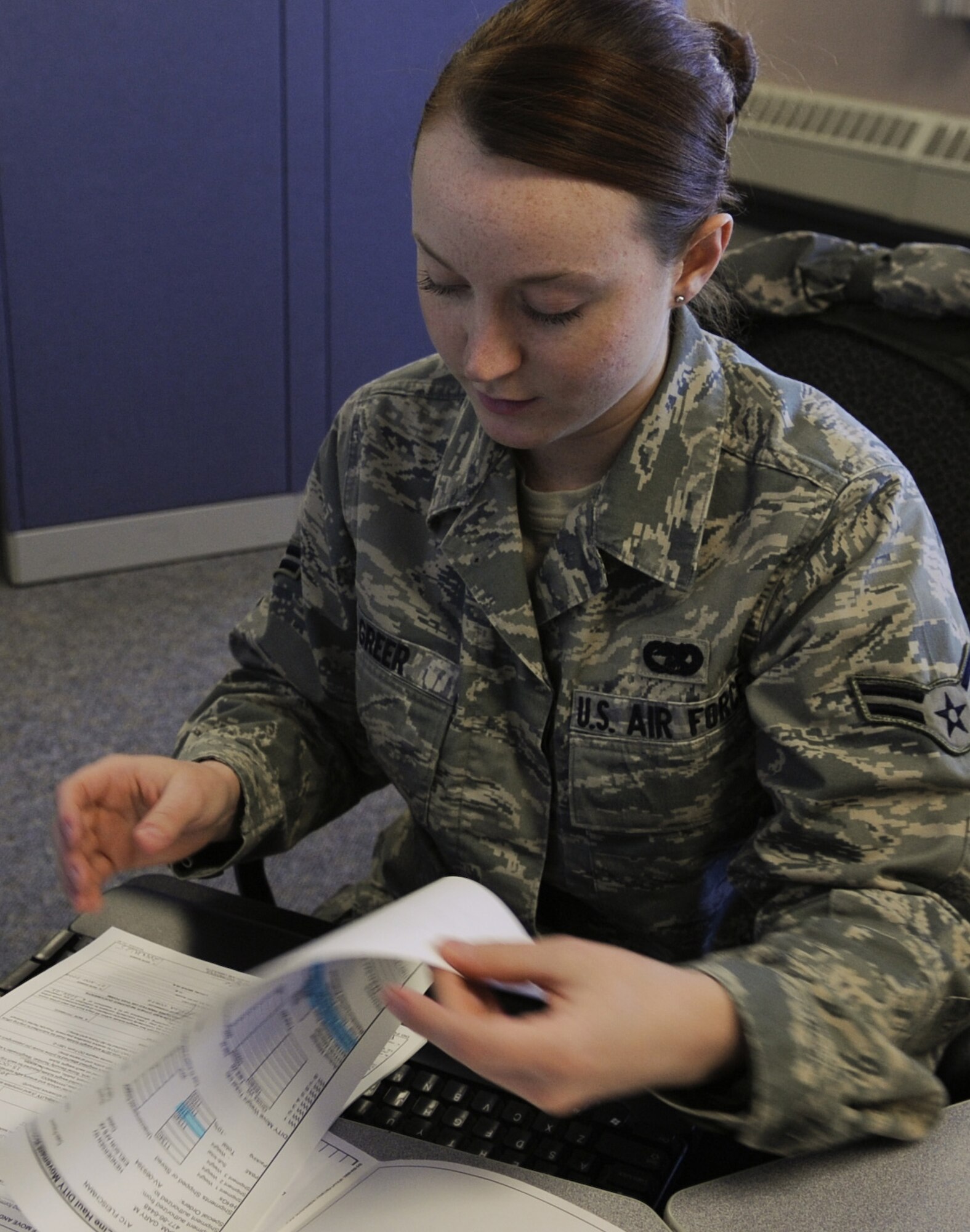 Airman 1st Class Katrina Greer, 354th Logistics Readiness Squadron Traffic Management Specialist reviews "do-it-yourself" paperwork Feb. 23, 2009, Eielson Air Force Base, Alaska.  The Traffic Management Office processes all the paperwork for moving household goods to and from the base. (U.S. Air Force photo/Airman 1st Class Laura Max)