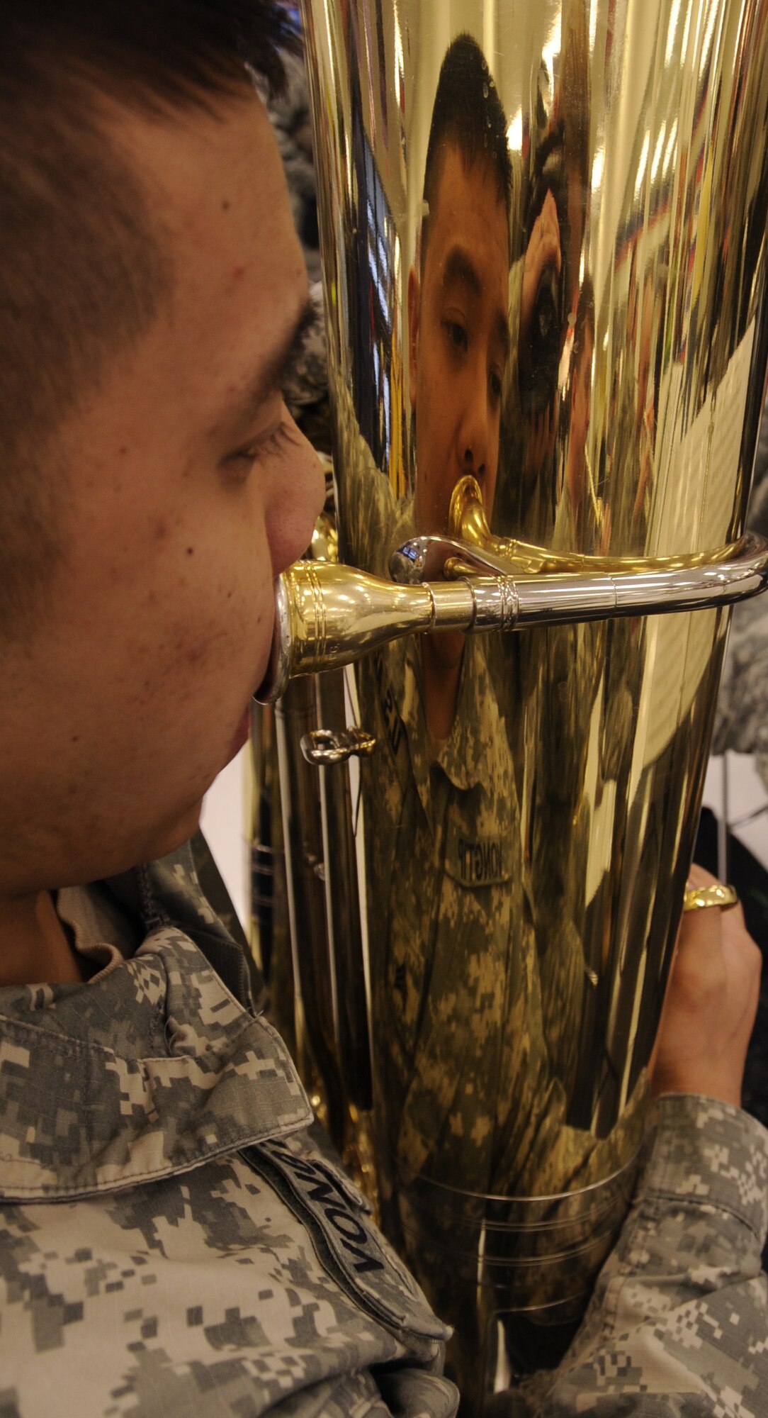 Sgt. Tenny Vongtip plays the tuba Feb. 20, 2009, Eielson Air Force Base, Alaska.  Sergeant Vongtip is with the 9th Army Band,Fort Wainwright, Alaska and is performing for the grand opening of the new shopping center at Eielson AFB. (U.S. Air Force photo/Airman 1st Class Laura Max) 