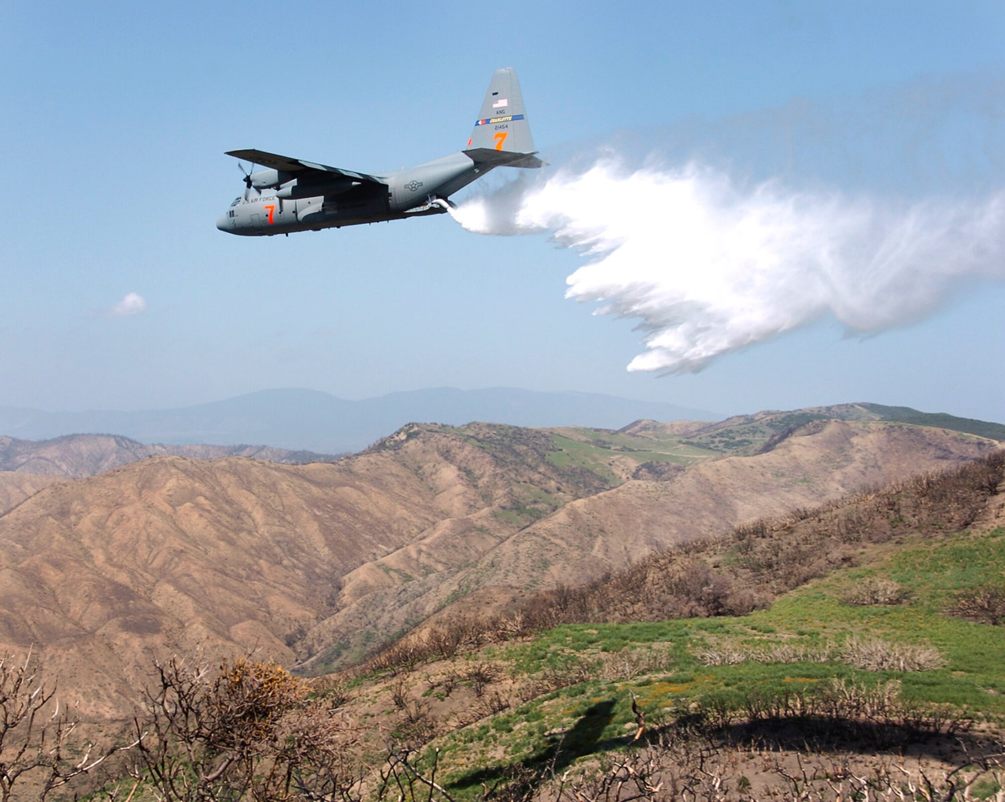 Los Padres National Forest, California. A C-130 Hercules cargo plane assigned to the 145th Airlift Wing, North Carolina Air National Guard, drops 3,000 gallons of water over the Los Padres National Forest using Modular Airborne Fire Fighting System (MAFFS) during the MAFFS 2008 annual certifying event. The annual training event includes all aircrew, maintenance, support personnel directly supporting the MAFFS mission. There are 4 Air National Guard and Air Force Reserve units involved with MAFFS: 145th Airlift Wing, (Charlotte), 146th Airlift Wing (Channel Islands), 153rd Airlift Wing, (Wyoming) and the 302nd Airlift Wing (Colorado). Photo by Tech Sgt Brian E. Christiansen