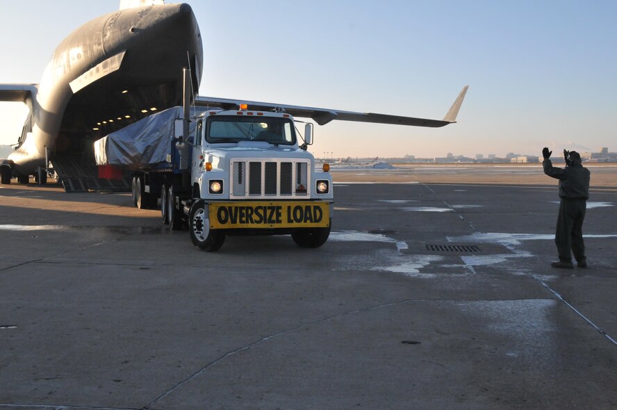 A section of the Express Logistics Carrier for the International Space Station is loaded aboard a C-17 from Dover Air Force Base, Del. Feb. 8 for transport into space on the Space Shuttle.  The carrier is manufactured in Big Lake Minn. and allows long term storage of items for future use at the space station.(Air Force Photo/Master Sgt. Paul Zadach)