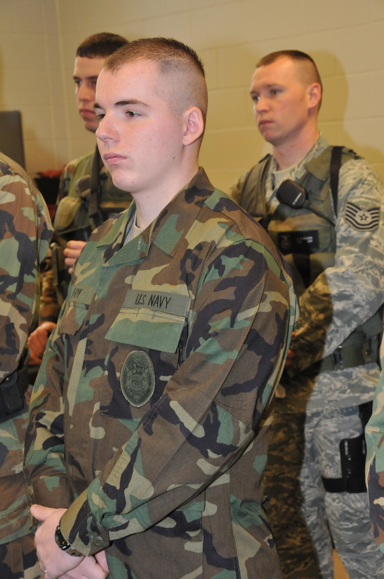 Navy Master at Arms Seaman Matthew Foy stands at guard mount with 934th Security Forces members. The Navy members train and work with 934th Airlift Wing Security Forces Squadron members to provide security at Minneapolis St. Paul International Airport Air Reserve Station.(Air Force Photo/Master Sgt. Paul Zadach)