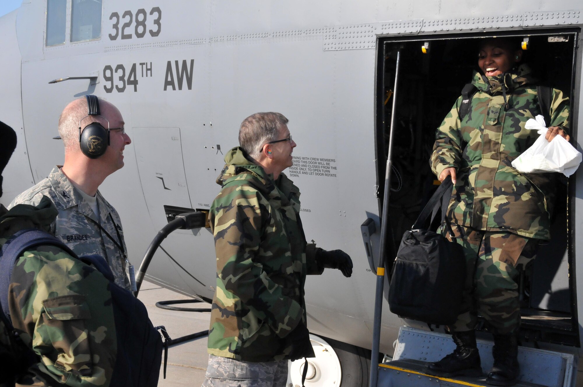 Senior Airman Carlisa Patton is greeted by Cols. Tim Tarchick and Eric Brandes as she returns from a deployment to Germany Feb. 7. (Air Force Photo/Master Sgt. Paul Zadach)