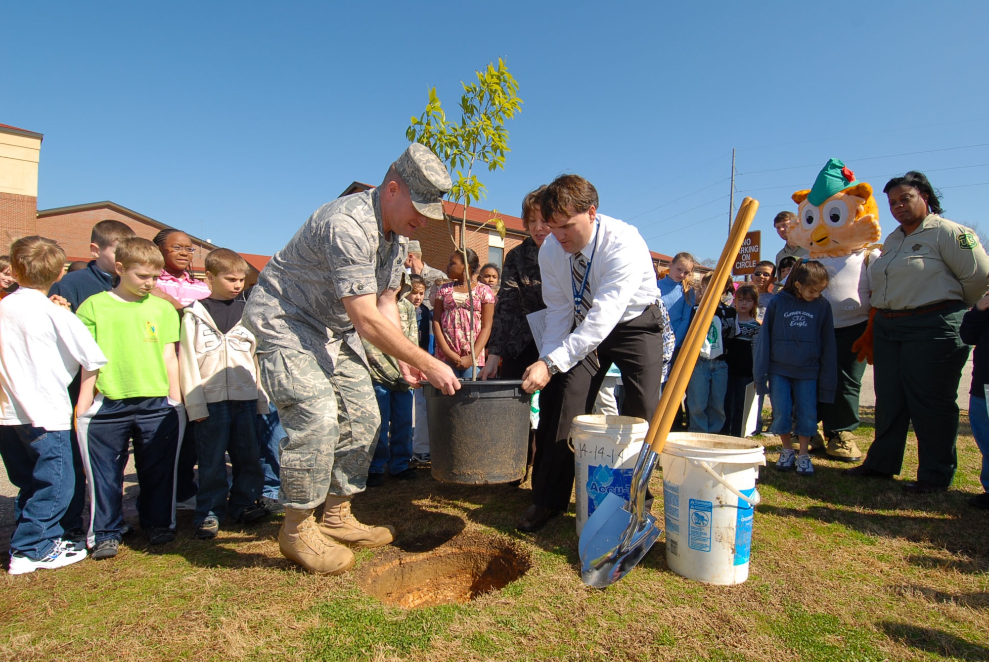 Col. Kris Beasley, 42nd Air Base Wing commander, and Brian Perry, Maxwell Elementary School assistant principal, plant a tree commemorating Arbor Day at the school Feb. 19. (Air Force photo by Jamie Pitcher)