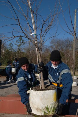Officer trainees Kent Germaine and Joseph Payne load trees on a trailer Saturday to be delivered to residents of Prattville, Ala., who lost trees due to a tornado in February 2008. Officer Training School students assisted the city in planting 1,000 trees on Arbor Day to help replace the trees destroyed by the tornado. (Air Force photo by Donna Burnett)