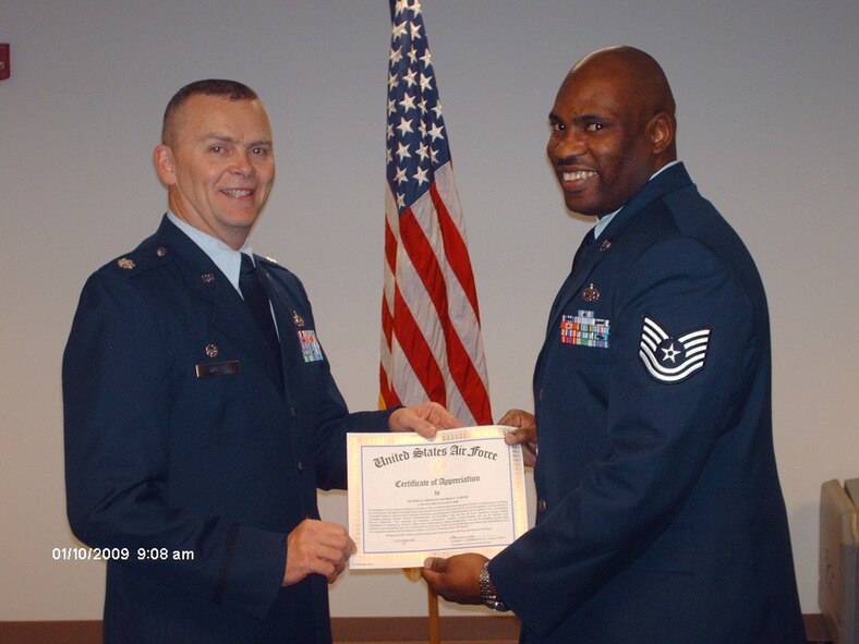 SEYMOUR JOHNSON AIR FORCE BASE, N.C. -- Tech. Sgt. Maurice Carter (right)  receives a Certificate of Appreciation from Lt. Col James Horton on behalf of the 916th Wing commander..  In recognition of Sgt. Carter's  leadership, ofessionalism and management ability in preparing and executing a successful inspection preparation and bed down plans for recent wing inspections.