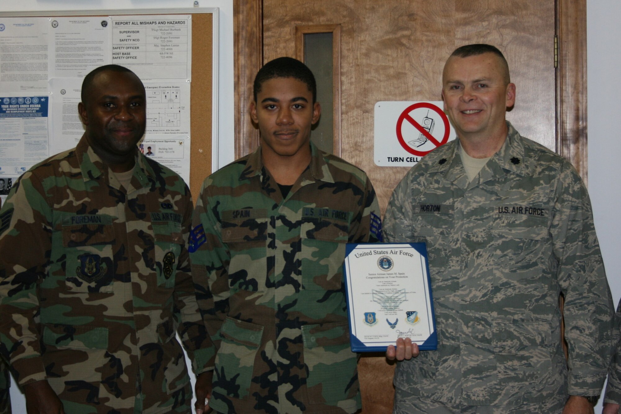 SEYMOUR JOHNSON AIR FORCE BASE, N.C. -- Reservist James Spain (center), is promoted to the rank of senior airman by Lt. Col. James Horton (right), 916th Communication Squadron commander and Staff Sgt. Roger Foreman.