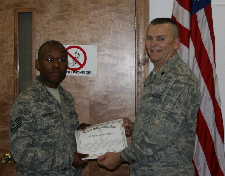 SEYMOUR JOHNSON AIR FORCE BASE, N.C. -- Tech. Sgt. TJ Brown III (left), computer operator technician, receives a Certification of Appreciation from Lt. Col James Horton, 916th Communications Squadron commander.  Presented on behalf of the wing commander, the certificate was In recognition of Sgt. Brown's leadership, professionalism and management ability in preparing and executing a successful inspection preparation and bed down plan for recent inspections at the Reserve wing.