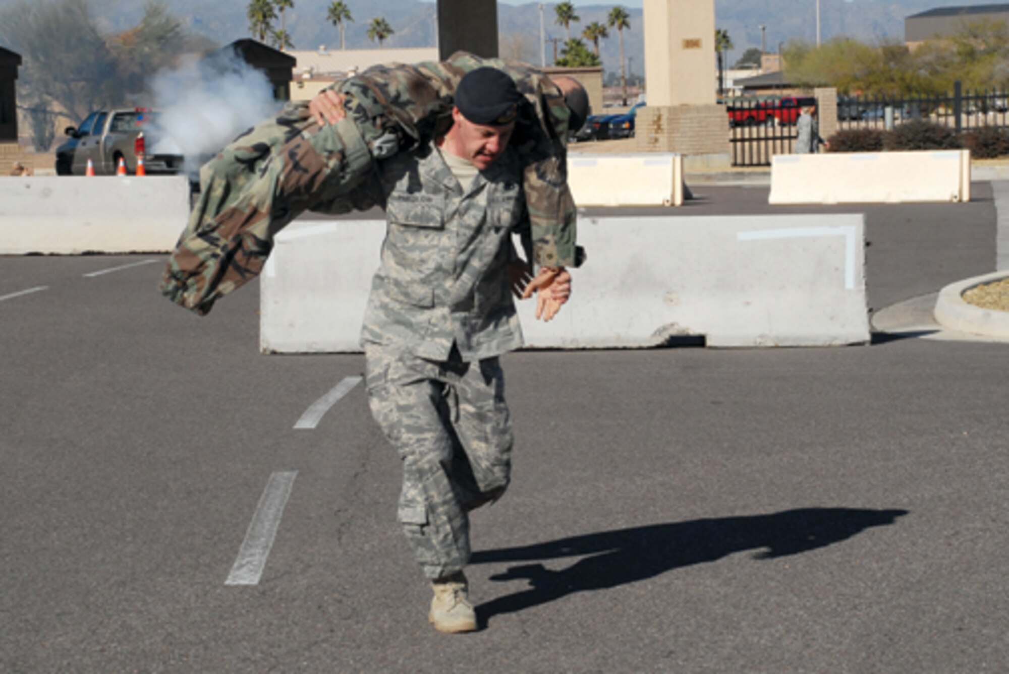 Staff Sgt. Jason Purslow, 56th Security Forces Squadron NCO-in-charge of pass and registration, carries a body from the scene of an explosion at the South Gate during exercise Crown Talon 09-01 Feb. 11. The focus of the exercise was shifted to what will specifically be evaluated during the unit compliance inspection in May. The focus areas included resource protection, force protection conditions, mobility bag and weapons issue, and specific objectives for major accident response exercises.
(U.S. Air Force photo/ Airman 1st Class Tracie Forte)