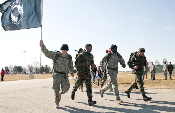 (Left to right) Tech. Sgt. David Jackson, 512th Logistics Readiness Flight, Staff Sgt. Michael Spencer, 512th LRF, Staff Sgt. Sean Fishburne, 436th Logistics Readiness Squadron, and Chief Master Sgt. Howard Heisey, 436th LRS, run to the finish line at the Air Mobility Command Museum during the 10th Annual Ruck March. (U.S. Air Force photo/ Roland Balik)
