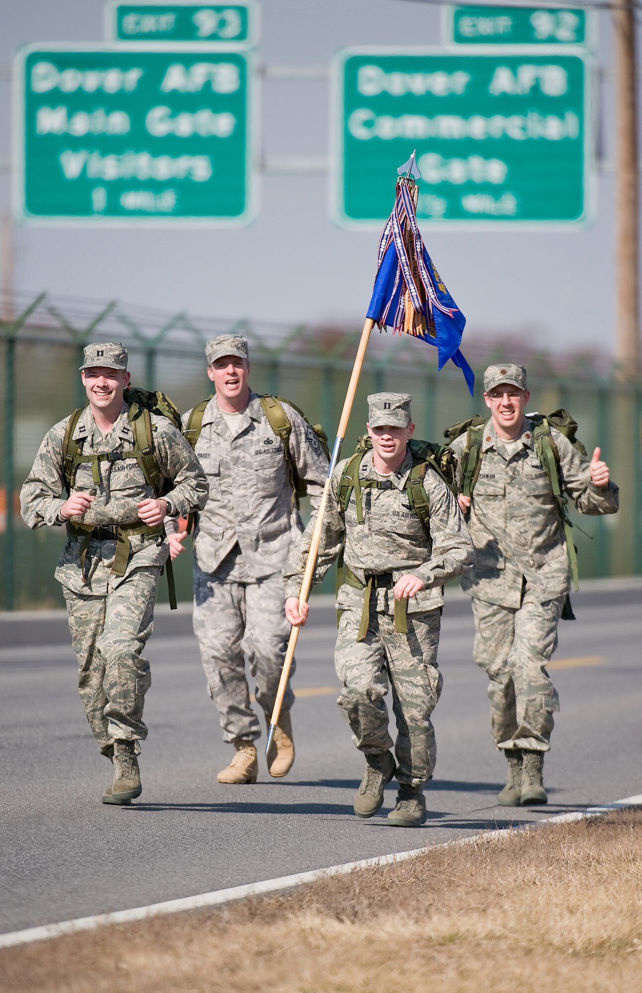 From left to right, 3rd Airlift Squadron team members Capt. Matthew Robinson, Master Sgt. William Baisey, Capt. Matthew Humphrey, and Maj. Michael Schwan carry their squadron guidon during the 10th Annual Ruck March Feb. 21 at Dover Air Force Base, Del. Twenty-eight, four-person teams strapped on 30-pound ruck sacks and ran or walked 6.2 miles to compete in the annual event hosted by the 436th Security Forces Squadron to commemorate the veterans of the Korean War who fought in the Battle of Chosin Reservoir. (U.S. Air Force photo/Roland Balik)