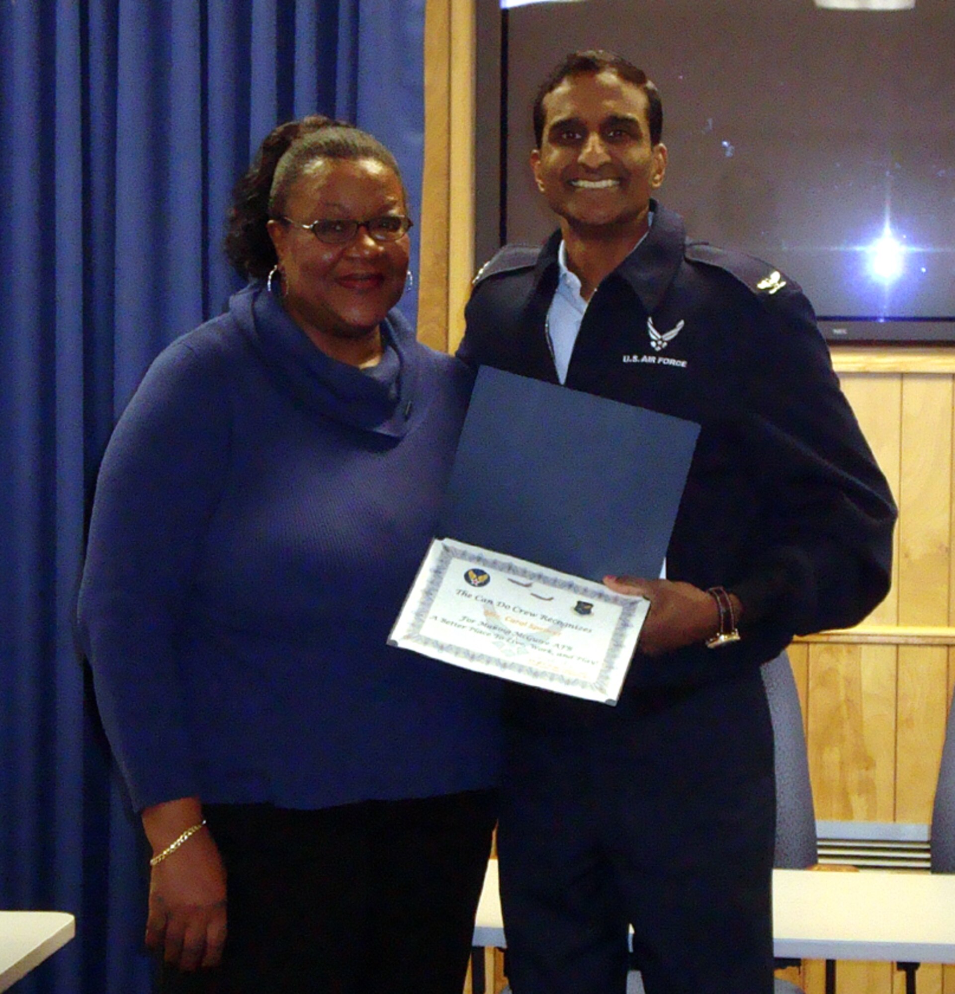 Col. Balan Ayyar, 305th Air Mobility Wing commander, presents a Can Do Crew award to Carol Spencer, Airman and Family Readiness Center community readiness consultant. “Ms. Spencer epitomized the ‘Can Do’ spirit Oct. 13, Columbus Day, when she aided a young Airman who was in dire need of monetary assistance. The Airman needed a Falcon Loan to help cover expenses associated with dental care for her husband; dental surgery was to take place later that afternoon. To top matters off, the Airman had recently been released from the hospital after undergoing minor surgery.  Without a second thought or hesitation, Ms. Spencer volunteered her off-duty time and reported to work at 8 a.m. that day to meet the member and assist her with the Air Force Aid Society’s Falcon Loan application process. From start to finish, the Air Force member was able to receive the necessary funding within 45 minutes, which helped alleviate any stress and anxiety she was experiencing. Ms. Spencer’s ‘Can Do’ work ethic, spirit, and professionalism are a direct reflection on the A&FRC and Team McGuire. I’m glad we have this member on our team.”