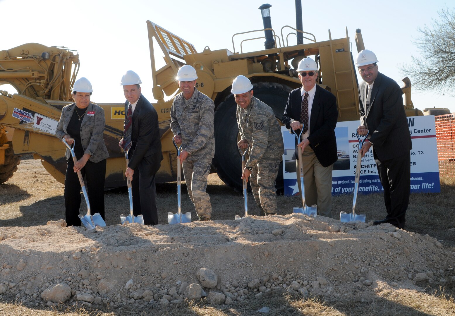 Yvette Blakely (from left), Randolph Base Exchange sales and merchandise manager; Mike Einer, BX store manager; Col. Alan Lake, 12th Mission Support Group commander; Tech. Sgt. Juan Nieves, 12th Medical Group; Sid Hoover, 12th Civil Engineer Division structural engineer; and Richard Trevino, 12th Civil Engineer Division director; turn the dirt Feb. 20 during a groundbreaking ceremony for the new BX. Sergeant Nieves was selected to represent the customers the BX serves each day. (U.S. Air Force photo by Steve White)