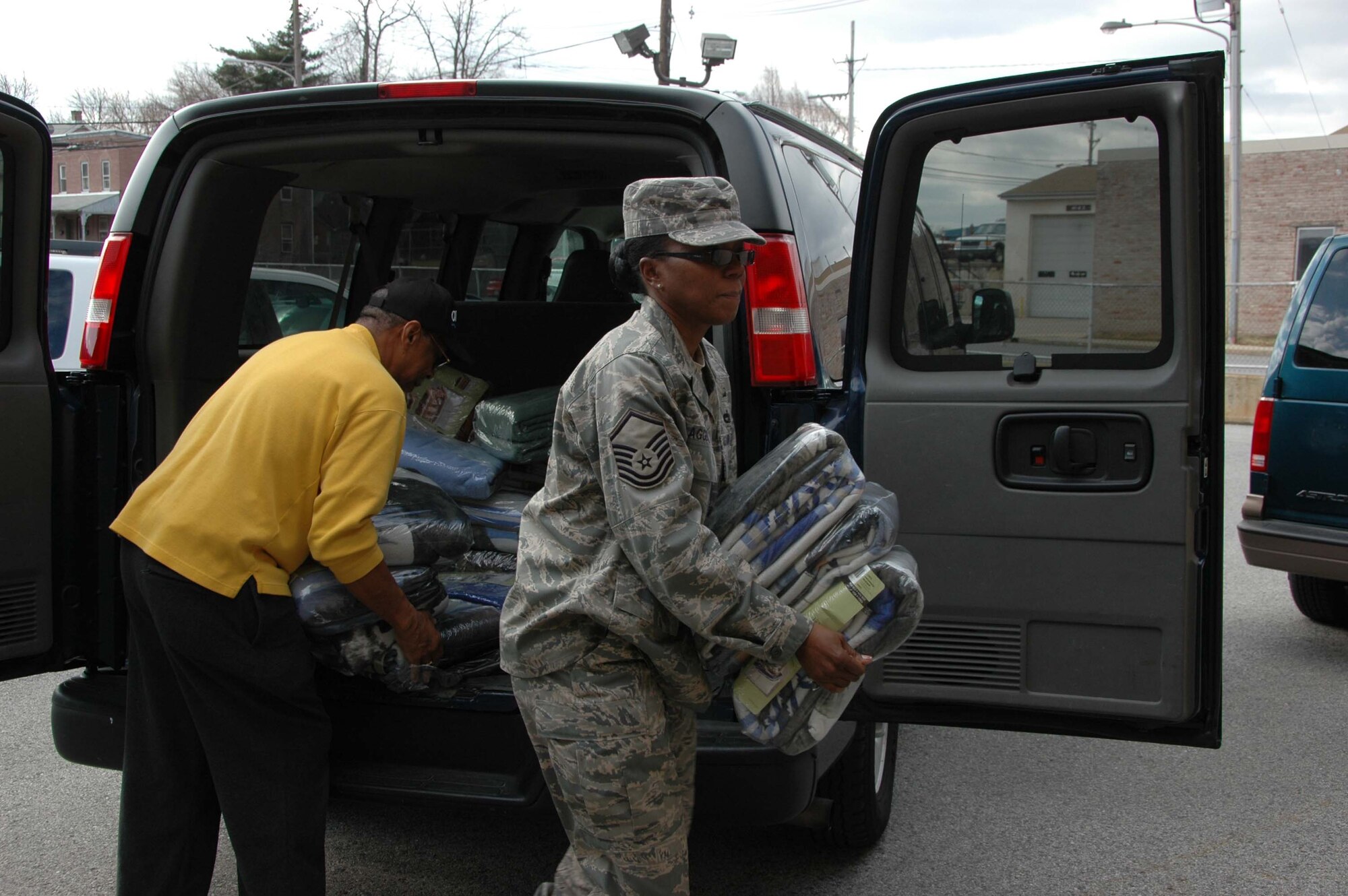 COATESVILLE, PA. -- Master Sgt. Sebrena Flagg-Briggs with the 514th Air Mobility Wing, delivers blankets donated to help victims of the recent rash of arsons in Coatesville, PA.  As part of its community outreach program members of the Air Force Reserve wing based at McGuire Air Force Base, N.J., organize coat drives to support area homeless shelters and charitable organizations. (U.S. Air Force photo/Master Sgt. Donna T. Jeffries)