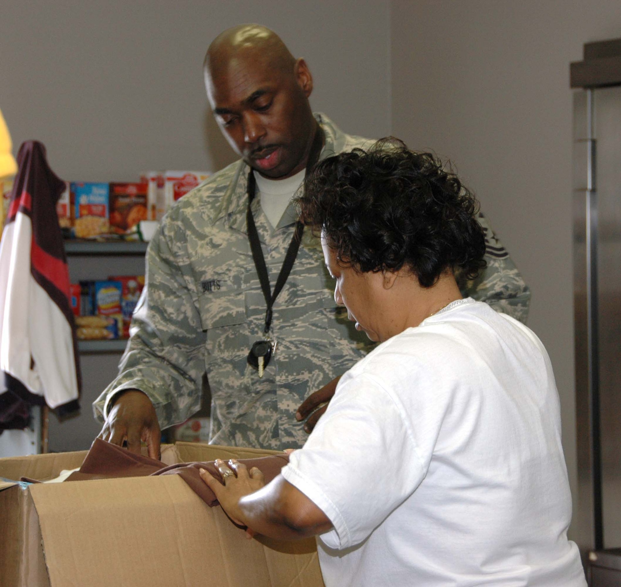 COATESVILLE, PA. -- Senior Master Sgt. Charles Butts, a first sergeant with the 514th Air Mobility Wing, works alongside a volunteer sorting items donated to help victims of the recent rash of arsons in Coatesville, PA.  As part of its community outreach program, members of the Air Force Reserve wing based at McGuire Air Force Base, N.J., organize coat drives to support area homeless shelters and charitable organizations. (U.S. Air Force photo/Master Sgt. Donna T. Jeffries)