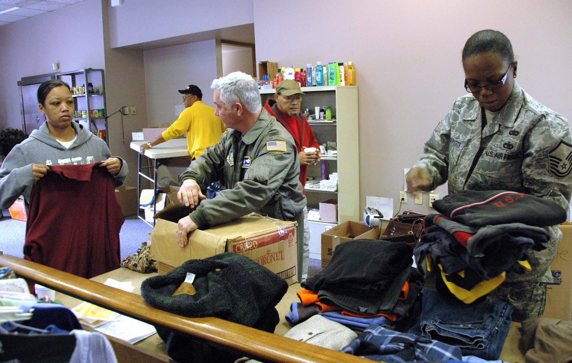 Coatesville, PA. -- Master Sgt. Sebrena Flagg-Briggs and Col. James DiFrancesco, both Reserve members of the 514th Air Mobility Wing, work alongside volunteers in a collection facility that supports the victims of the recent rash of arsons in Coatesville, PA. Sergeant Flagg-Briggs has organized several coat drives to support area homeless shelters and charitable organizations. (U.S. Air Force photo/Master Sgt. Donna T. Jeffries)
