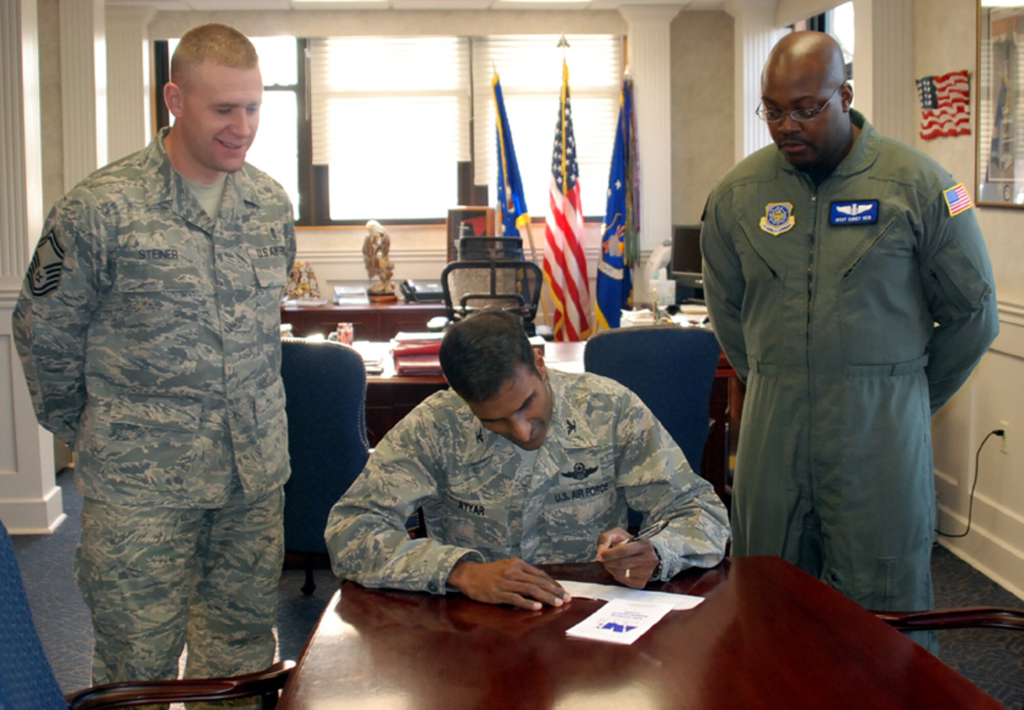 Col. Balan Ayyar, 305th Air Mobility Wing commander, fills out his donation form for the Air Force Assistance Fund here Feb. 20. Left, Senior Master Sgt. Joe Steiner, 305th Medical Group, and Master Sgt. Corey Reid, 6th Airlift Squadron, are the AFAF base POCs. Donations to the AFAF benefit four organizations, including the Air Force Aid Society, Air Force Village, Air Force Enlisted Village and LeMay Foundation. Donations can be given through squadron POCs until April 7. For more information, call Sergeant Steiner at (609) 754-9552 or Sergeant Reid at (609) 754-0561. (U.S. Air Force photo/Senior Airman Bekah Phy)