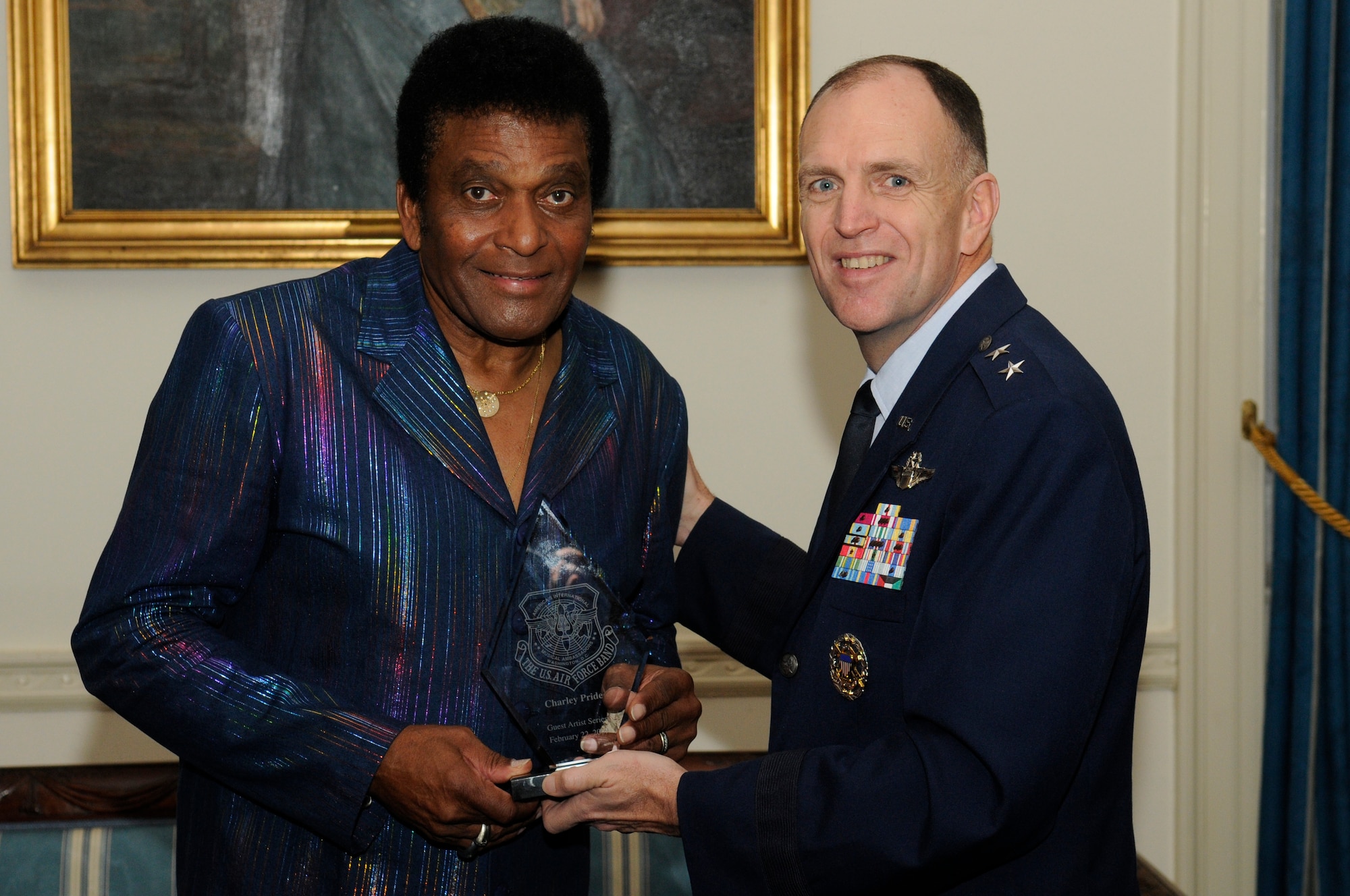 Maj. Gen. Ralph Jodice, Air Force District of Washington commander, presents Charley Pride, legendary Country Music Hall of Fame star, with an appreciation plaque after the completion of this year’s first Guest Artist Series concert at Daughters of the American Revolution Constitution Hall Feb. 22. A special performance was also given by this year’s Col. George S. Howard young artist competition winner Katherine Kohler with guest emcee Bernie Lucas, host of America’s Music on 98.7 WMZQ. (U.S. Air Force photo by Staff Sgt. Dan DeCook)