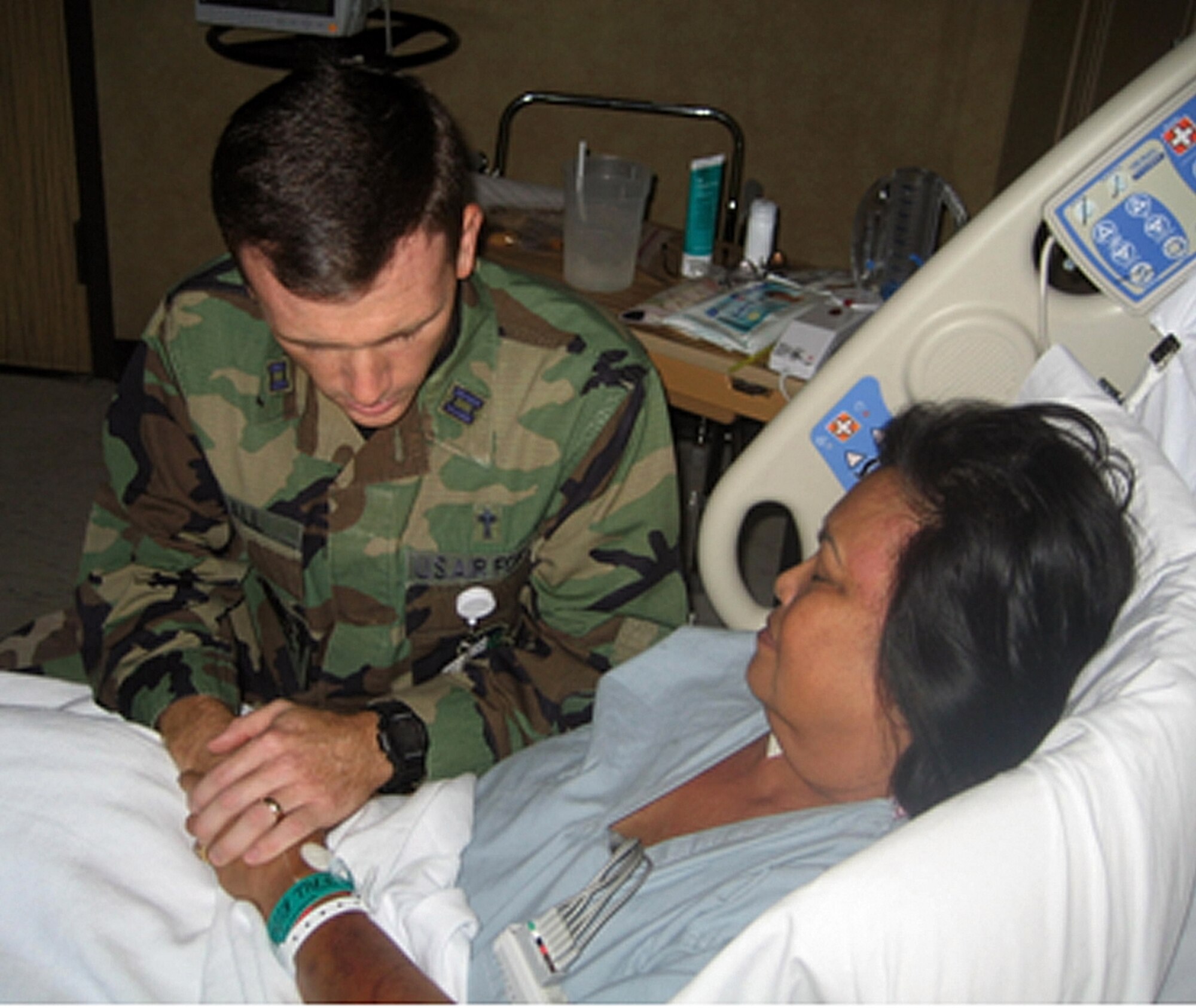 Chaplain (Capt.) Daniel Call prays with a patient at Wilford Hall Medical Center in October 2008. The 59th Medical Center Chapel staff received the 2008 Air Education and Training Command Outstanding Chaplain Corps Team Award, Medium Chapel Organization. (U.S. Air Force photo)