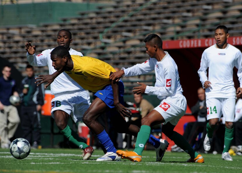 ABILENE, Texas - Barbados (yellow) competes in the second day of the CISM tournament against Suriname at Shotwell Stadium here, Feb. 22. Barbados won the game 3-2. On Feb. 21 Barbados defeated the United States 2-1 and Brazil defeated Canada 4-2. (U.S. Air Force photo by Airman 1st Class Stephen Reyes) 