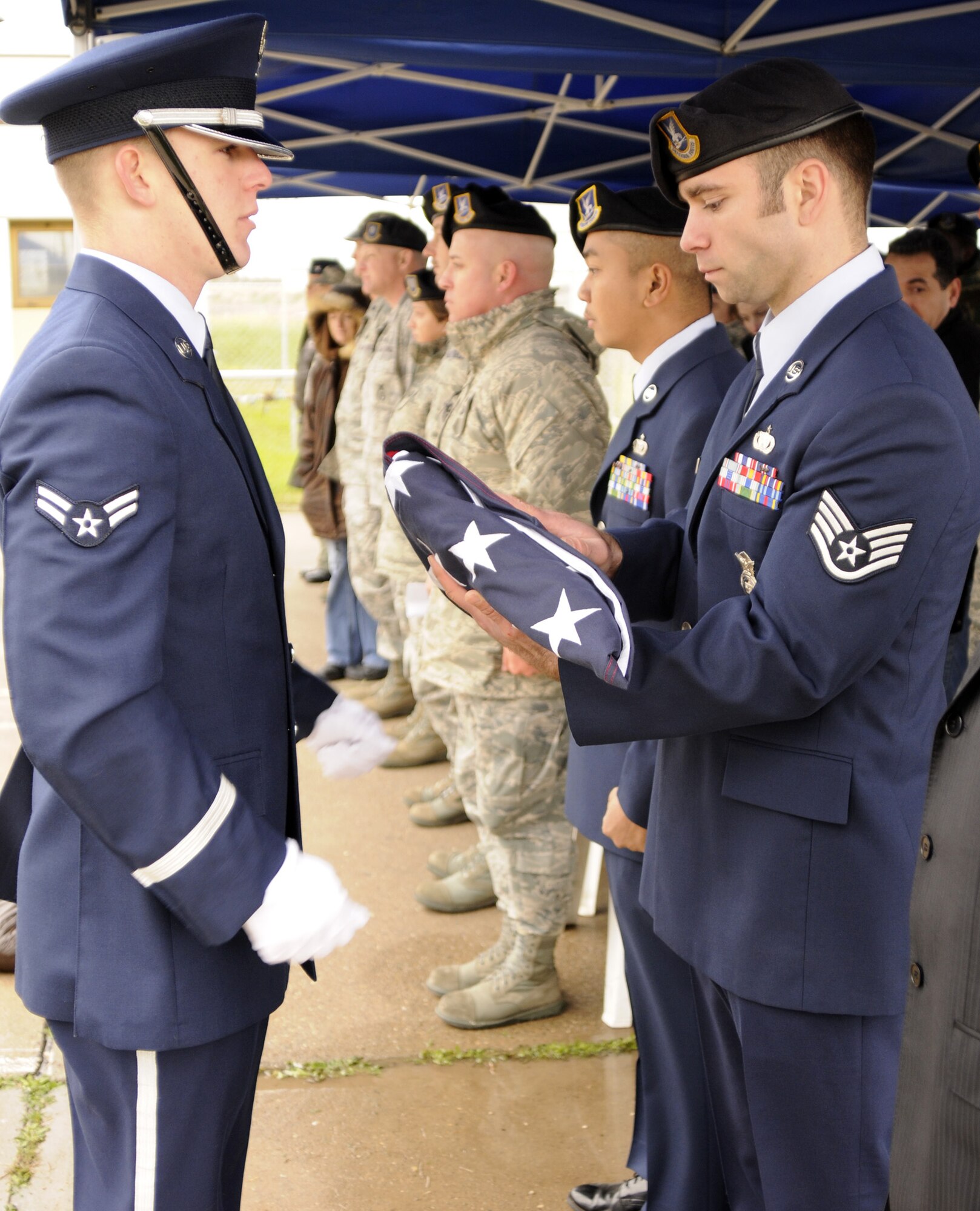 Airman 1st Class Brandon Bennett, member of Incirlik Base Honor Guard, presented the ceremony’s flag to Staff Sgt. Chris Smith, 39th Security Forces Squadron military working dog handler, Feb. 20 during the MWD memorial ceremony at the 39 SFS K-9 kennels.  Sergeant Smith was MWD Bak’s last handler before he passed Jan. 27. (U.S. Air Force photo by Airman 1st Class Amber Russell)