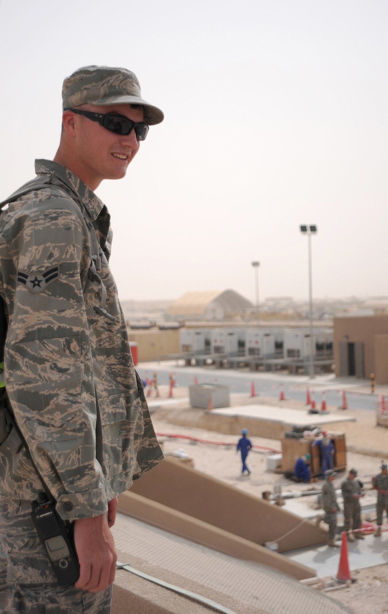 Airman 1st Class Luke Hoyt, a 379th Expeditionary Civil Engineer Squadron Third Country National Escort, performs an over-watch of off-base contract workers ensuring the security of the area and the safety of service members in the compound, Feb. 23, 2009, in an undisclosed location in Southwest Asia.  Airman Hoyt hails from Dubuque, Iowa and is deployed from Spangdahlem Air Base, Germany in support of Operations Iraqi and Enduring Freedom and Combined Joint Task Force - Horn of Africa.   (U.S. Air Force Photo by Airman 1st Class Andrew Satran/Released)