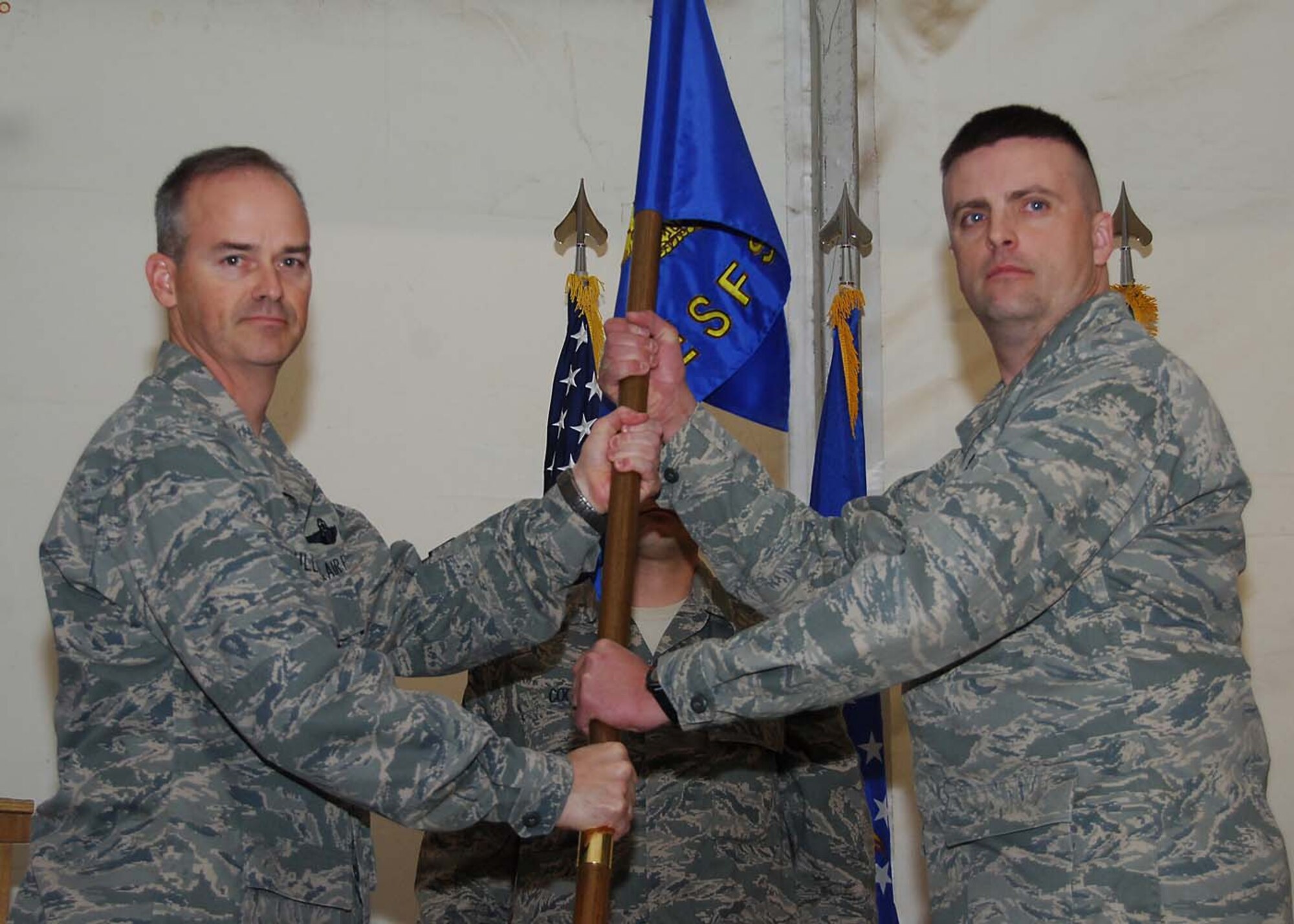SOUTHWEST ASIA -- Maj. Jeffery Becker, 387th Expeditionary Security Forces Squadron commander, receives command of the 387th ESFS from Col. John Sullivan, 387th Air Expeditionary Group commander, at an air base in Southwest Asia, Feb. 23. Major Becker is currently deployed from Keesler AFB, Miss. (U.S. Air Force photo/Senior Airman Courtney Richardson)
