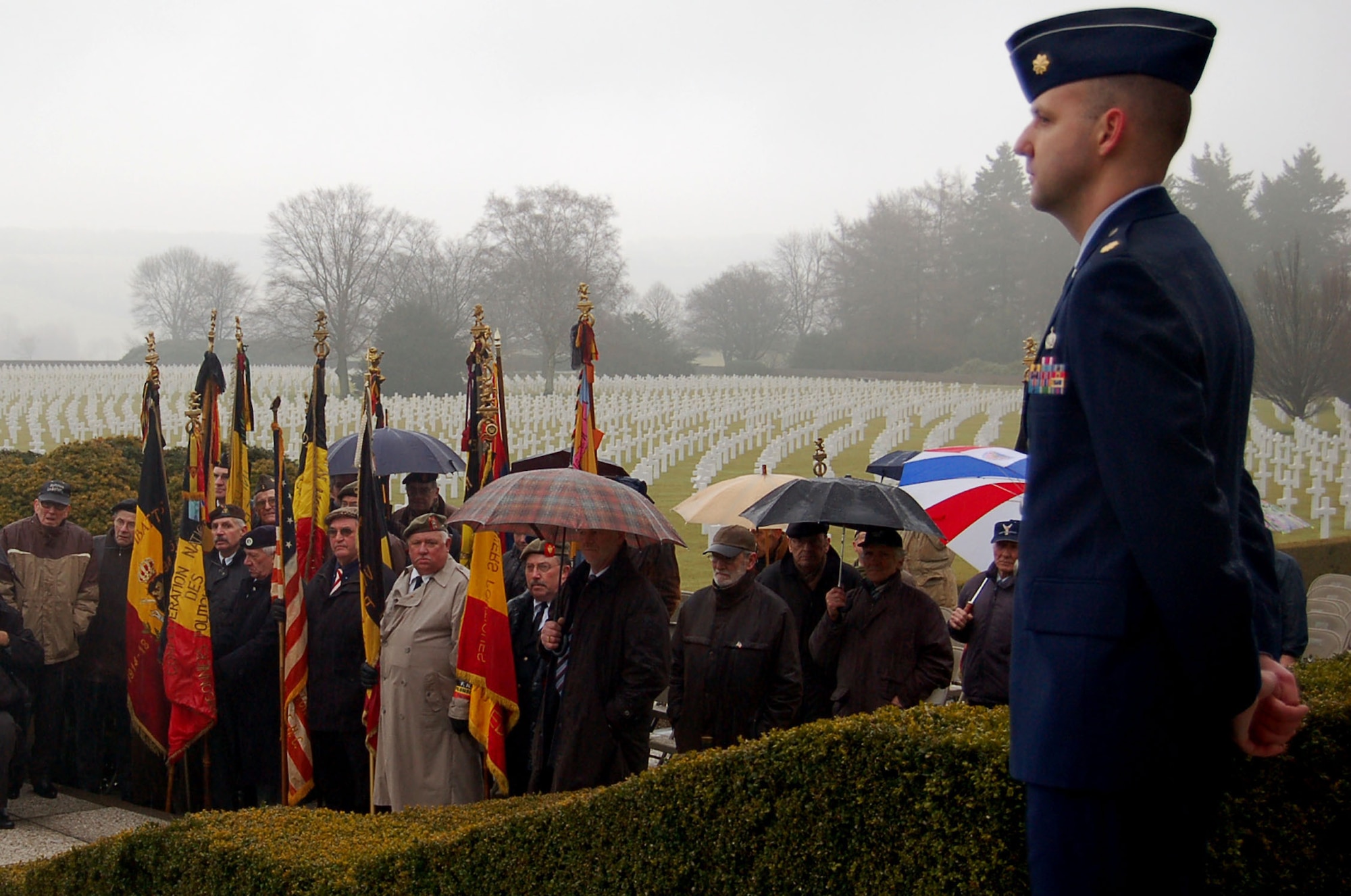 HENRI-CHAPELLE, Belgium -- Maj. Scott Johnson, U.S. senior national officer at the NATO Programming Centre, stands during a ceremony Feb. 20, 2009 at the Henri-Chapelle Cemetery and Memorial in Belgium. The event, which honored nine Airmen with the McMurray Crew in the 492nd Bombardment Group during World War II, drew international interest. (U.S. Air Force photo by 2nd Lt. Kathleen Polesnak)