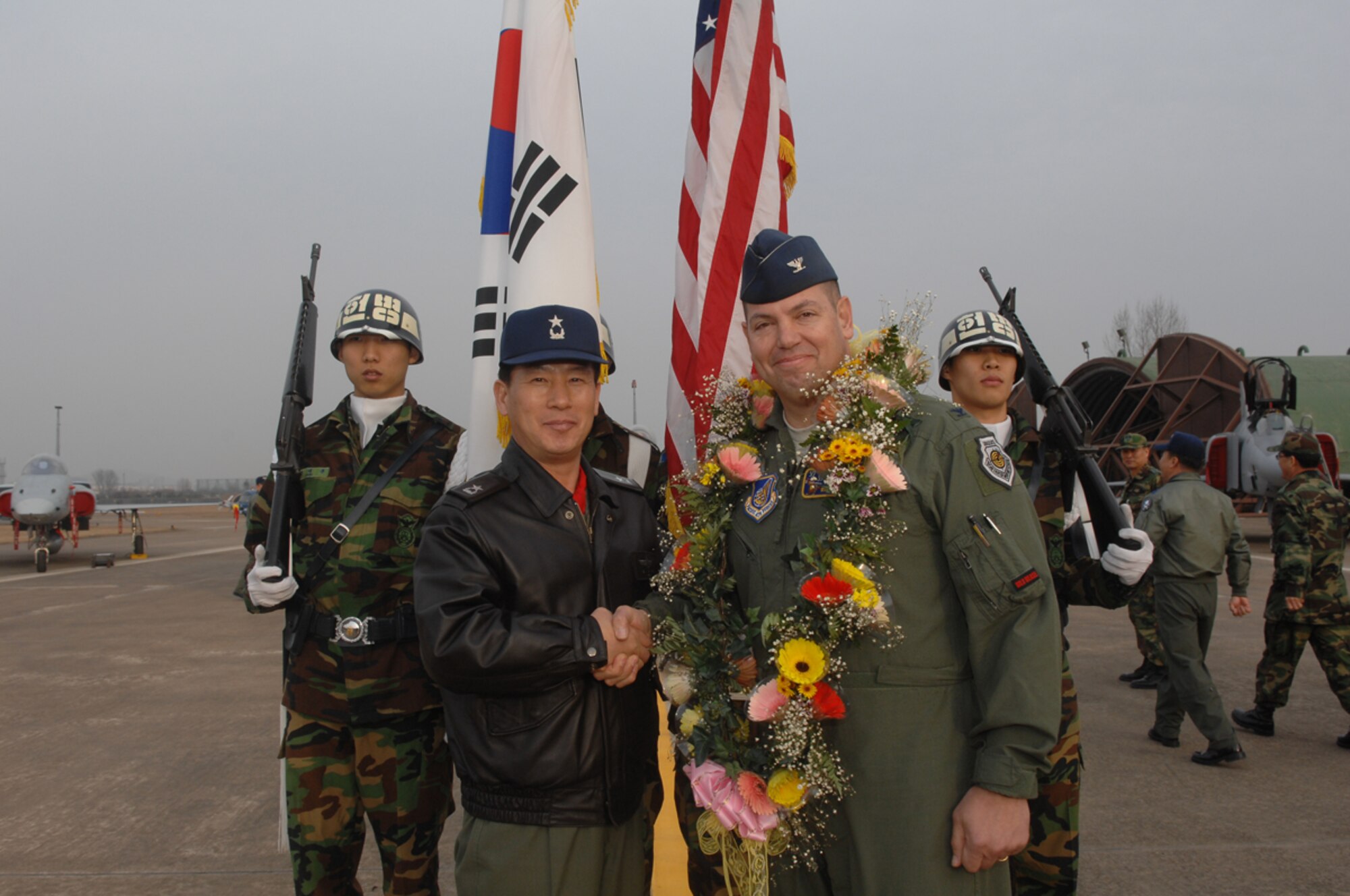 Korean airmen at Suwon welcome U.S.airmen from Japan during a ceremony, Feb 23, 2009. U.S. Air Force deployed 14 F-16s from Misawa Air Base, Japan, to Suwon Air Base, Republic of Korea, for a deployment. The approximately 500 airmen and 14 F-16s from Misawa's 35th Fighter Wing will work along-side ROK-US alliance partners to maintain peace and stability in the region. (Photo courtesy of ROKAF/PA)