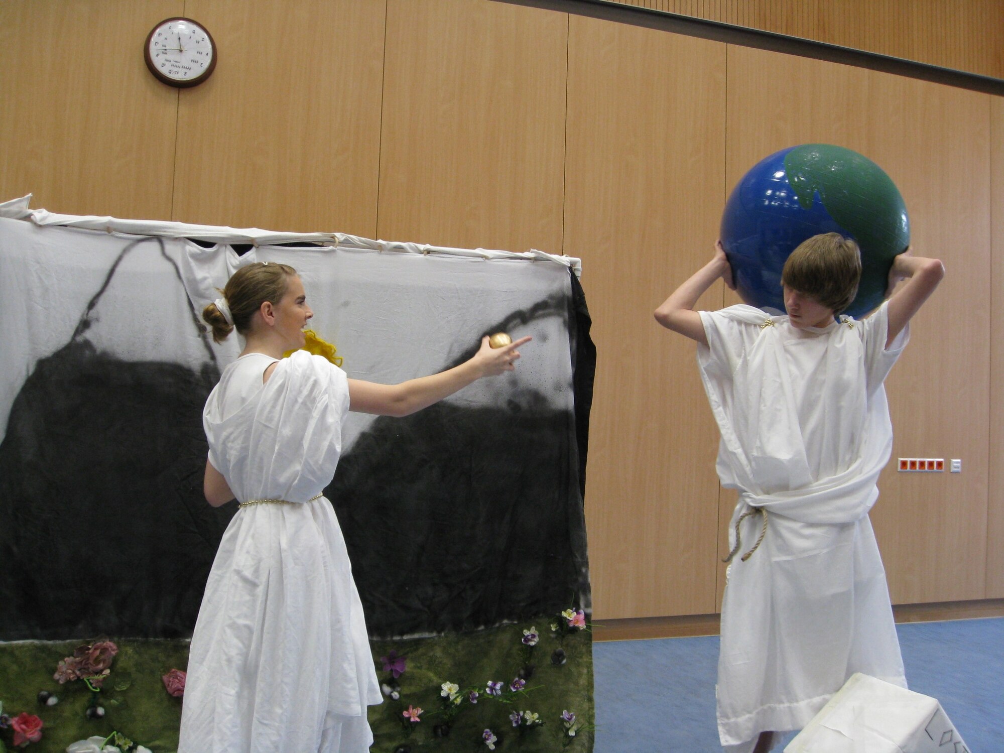 LANDSTUHL, Germany – Liz Buchholz, playing Heracles, holds a golden apple that she tricked Nate Sax, playing Atlas, into obtaining for her. Liz and Nate are Spangdahlem Middle School Students who participated in the 2008-2009 Odyssey of the Mind competition Feb. 21, 2009. Liz is the daughter of Libby Bennett and Tech. Sgt. Tommy Buchholz, 52nd Force Support Squadron. Nate is the son of Sandy and Maj. Mike Sax, 52nd Logistic Readiness Squadron. (U.S. Air Force photo by April Goetz)