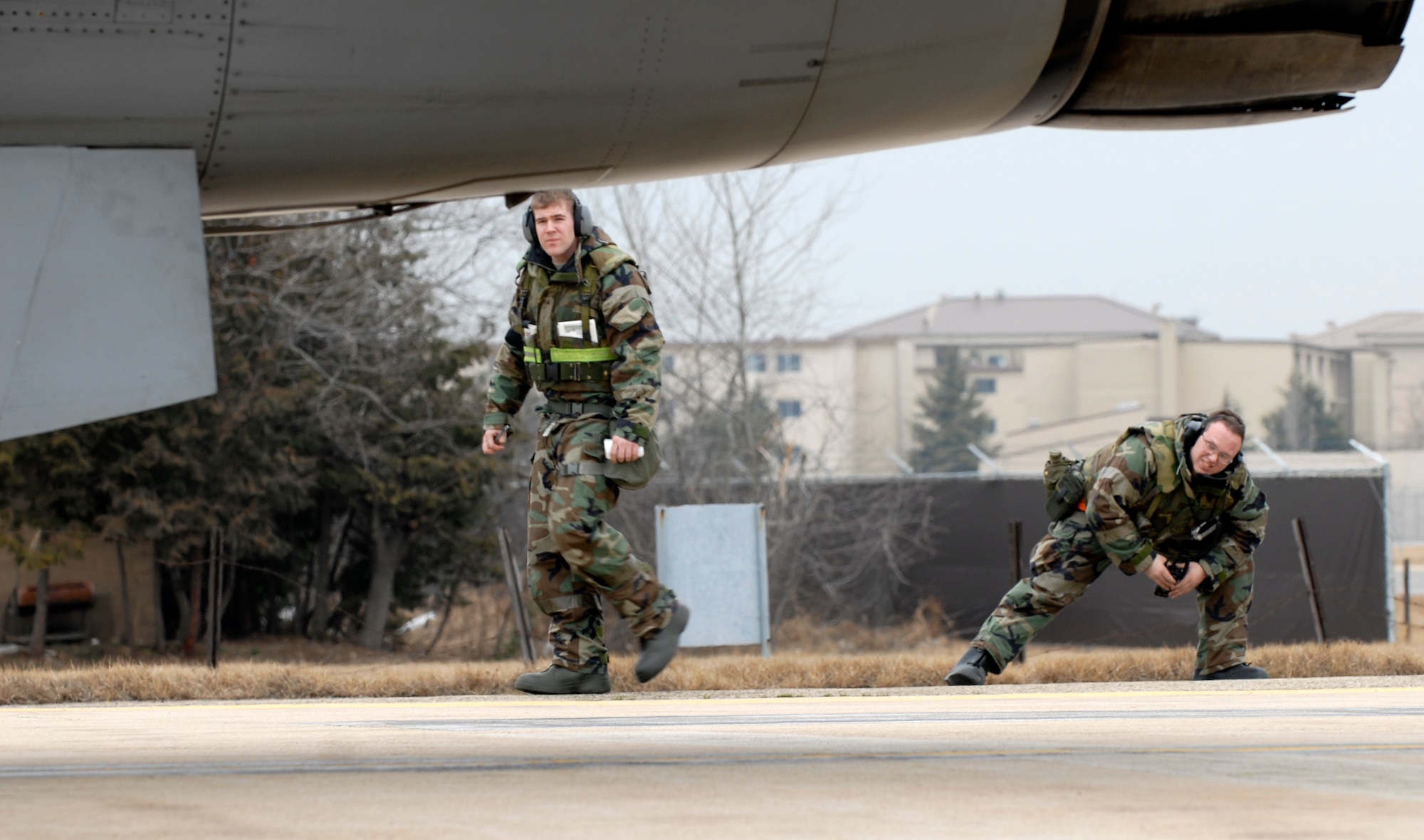 Staff Sgt Chris Medlock and Senior Airman Daniel Lane, both from the 8th Aircraft Maintenance Squadron, check for open panels and safety pins during an end of runway check at Kunsan Air Base, Republic of Korea, Feb 24, 2009. The EOR check is the final step before take-off. Kunsan's F-16 Fighting Falcons are flying multiple sorties a day while participating in the OperationalReadiness Exercise Beverly Midnight 09-01 (U.S. Air Force Photo by SSgt Jason Colbert)