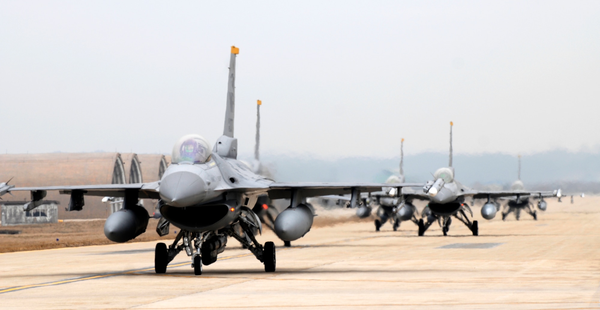 Aircraft from the 80th Fighter Squadron taxi down the runway for an end of runway check at Kunsan Air Base, Republic of Korea, Feb 24, 2009. Kunsan's F-16 Fighting Falcons are flying multiple sorties a day  while participating in the local operational readiness exercise Beverly Midnight 09-01 (U.S. Air Force Photo by SSgt Jason Colbert)