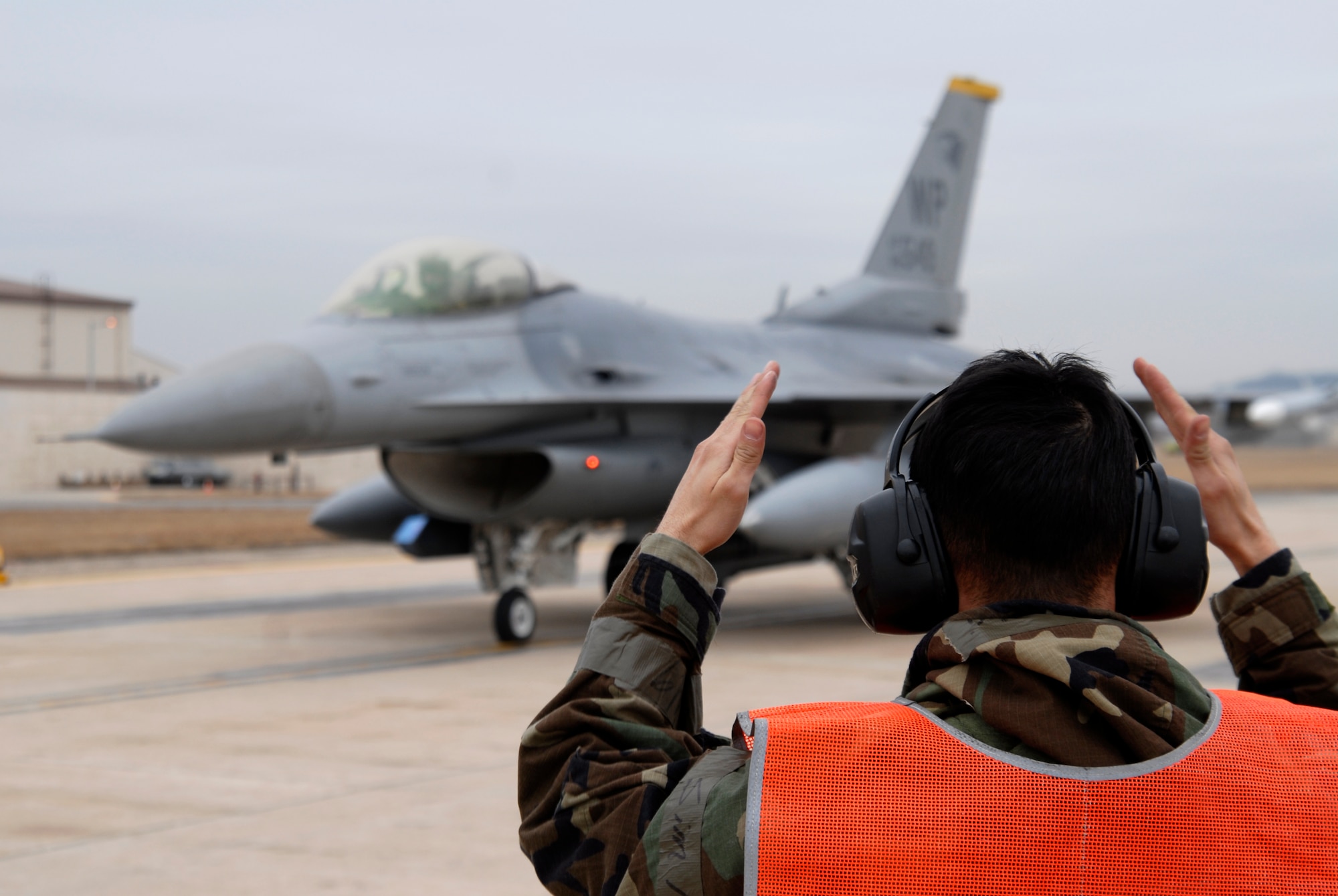 Staff Sgt. Rodolfo Cortez, 8th Aircraft Maintenance Squadron, marshalls Capt. Andre Senay, 35th Fighter Squadron, into position for end of runway checks at Kunsan Air Base, Republic of Korea, Feb 24, 2009. Kunsan Airmen are flying multiple sorties a day while participating in the Operational Readiness exercise Beverly Midnight 09-01 (U.S. Air Force Photo by SSgt Jason Colbert)