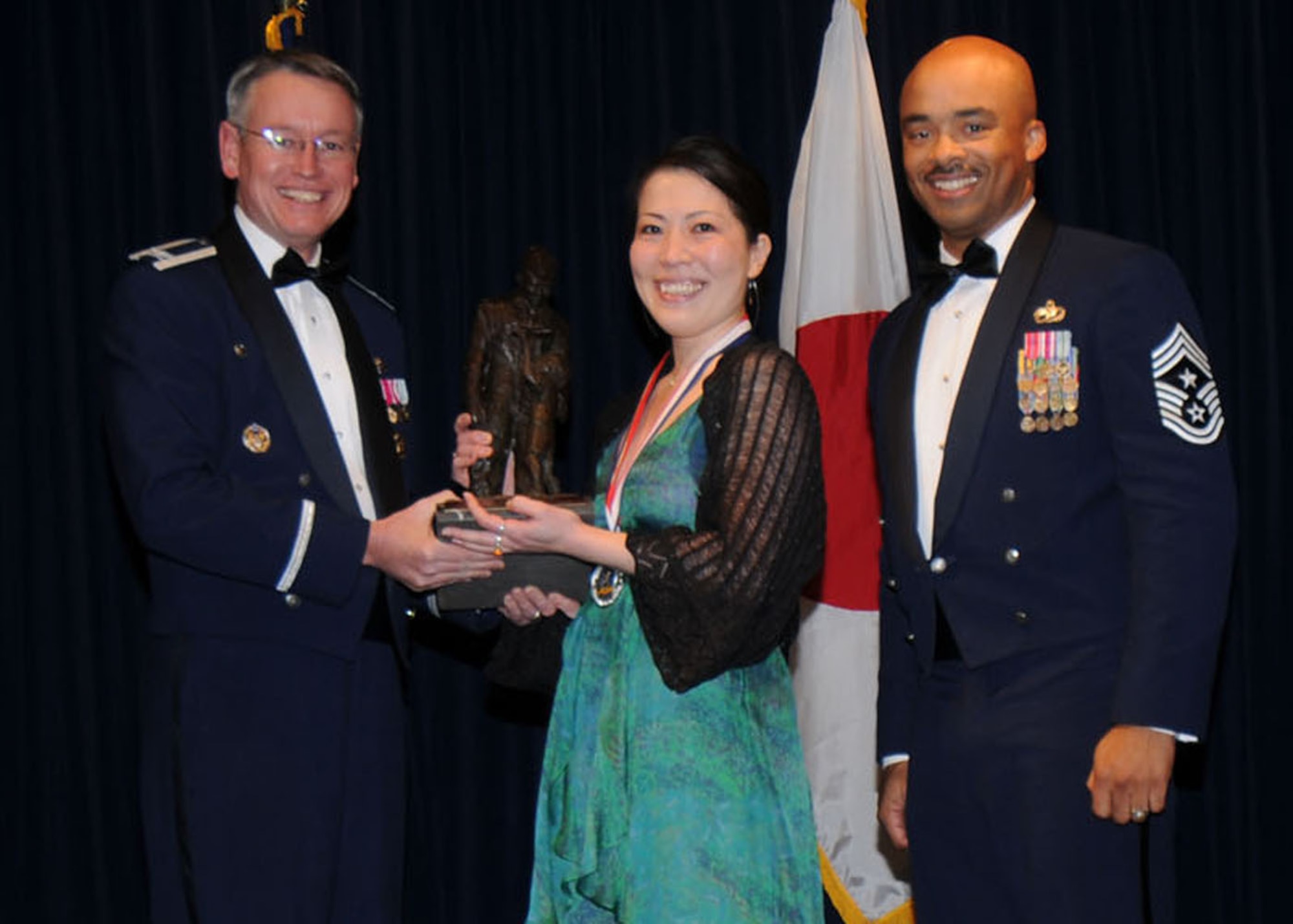 YOKOTA AIR BASE, Japan -- Colonel Jeff Newell, 374th Airlift Wing commander, and Chief Master Sgt. Linus Jordan, 374th AW command chief master sergeant, present Ms. Noriko Kosukegawa, center, with the Category 1 Civlian of the Year award Feb. 21. Ms. Kosukegawa is assigned to the 374th Medical Support Squadron. (U.S. Air Force photo/Senior Airman Veronica Pierce)
 
