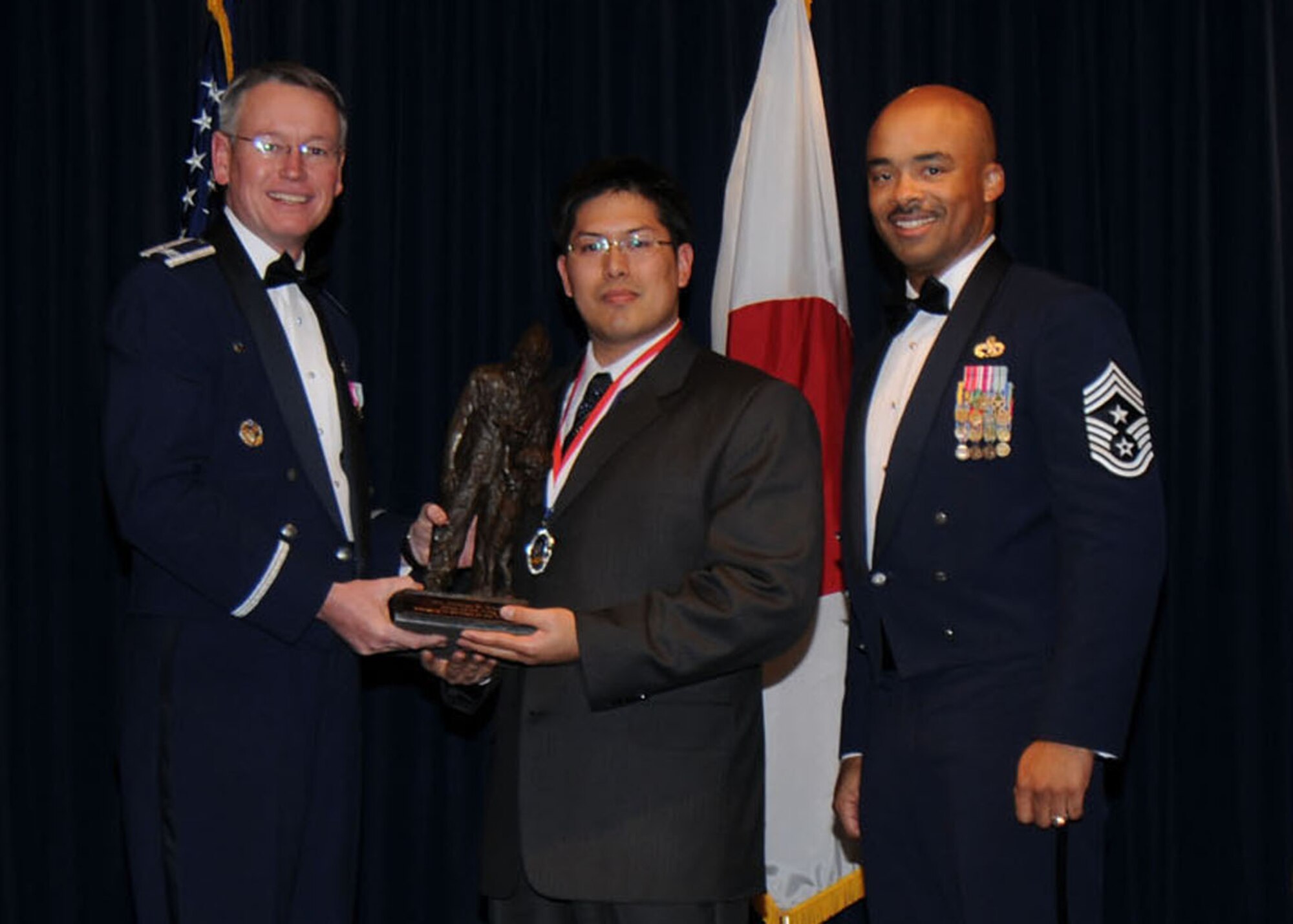 YOKOTA AIR BASE, Japan -- Colonel Jeff Newell, 374th Airlift Wing commander, and Chief Master Sgt. Linus Jordan, 374th AW command chief master sergeant, present Mr. Joshua Dunn, center, with the 374th AW Category 2 Civilian of the Year award Feb. 21. Mr. Dunn is assigned to the 374th Force Support Squadron. (U.S. Air Force photo/Senior Airman Veronica Pierce)
 
